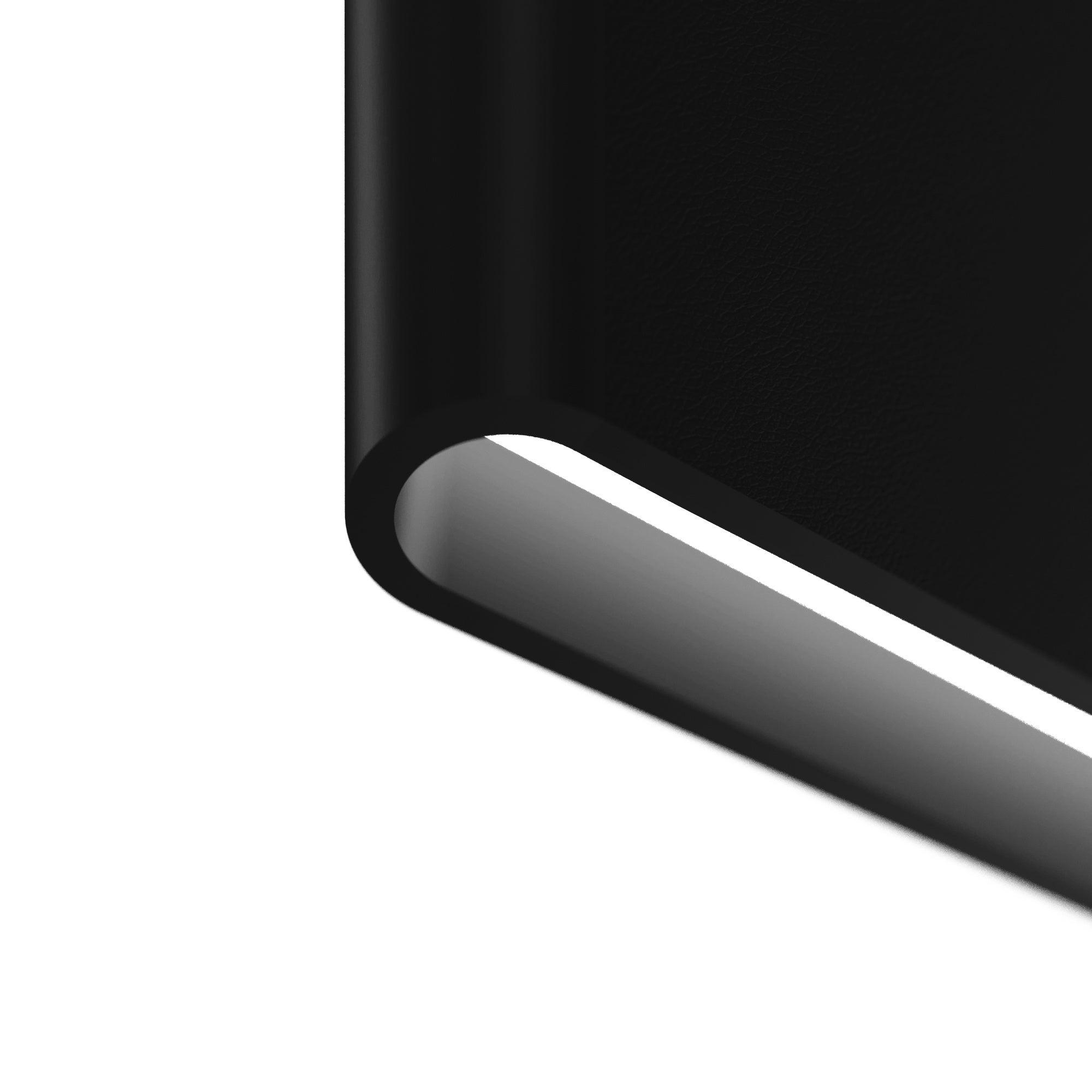 Close-up of white light strip beneath a dark rounded profile