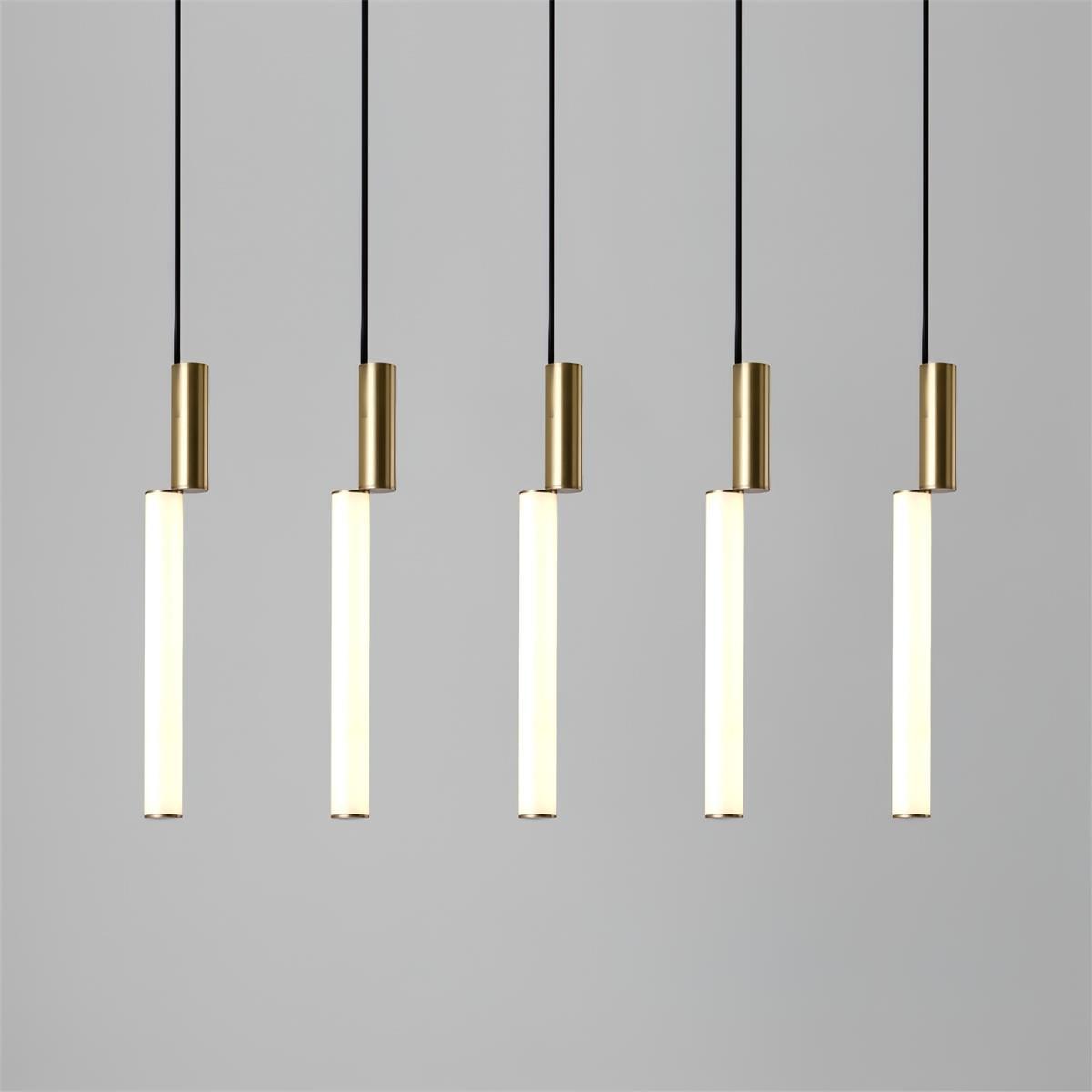 Five white acrylic light bars with gold upper cylinders suspended in a straight row