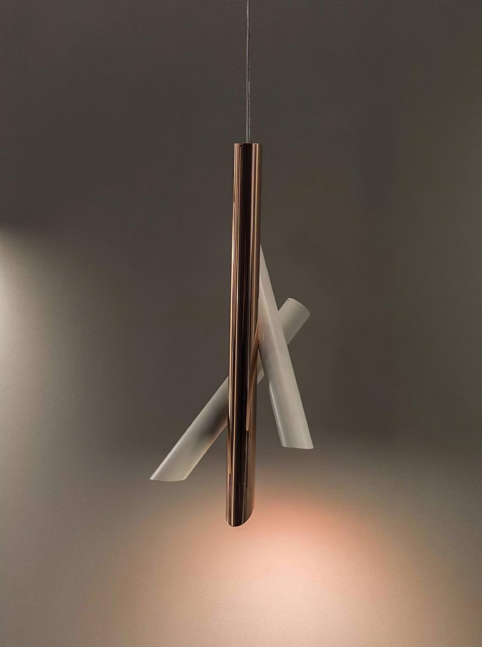 White and rose-gold Tubes pendant glowing near a corner in a dark setting