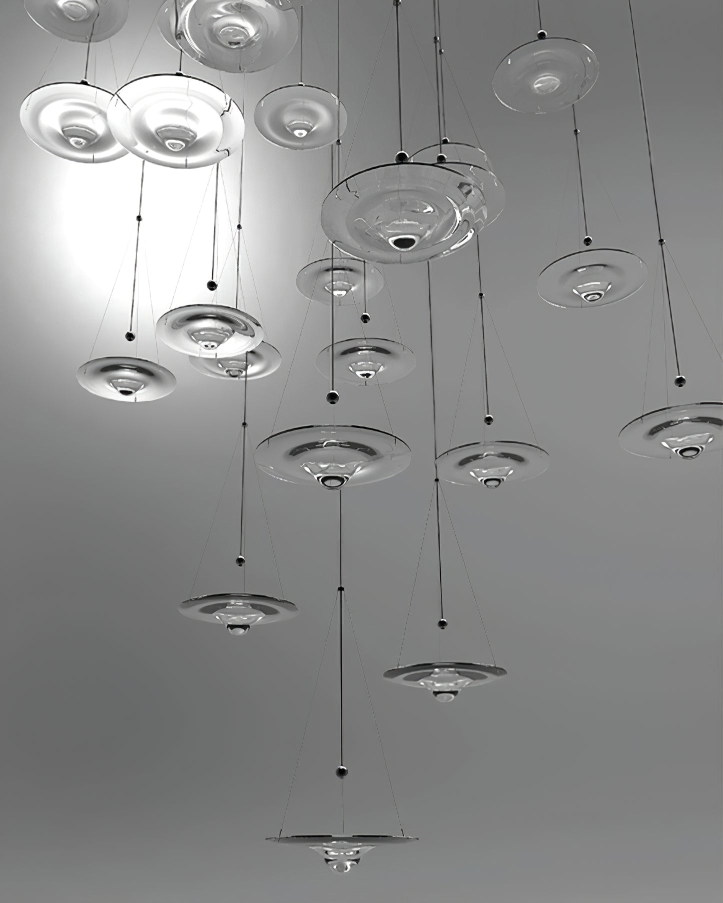 Tall installation of suspended glass discs