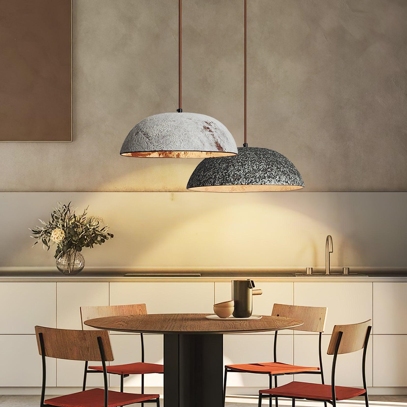 Two ceramic half-dome pendants above a dining table