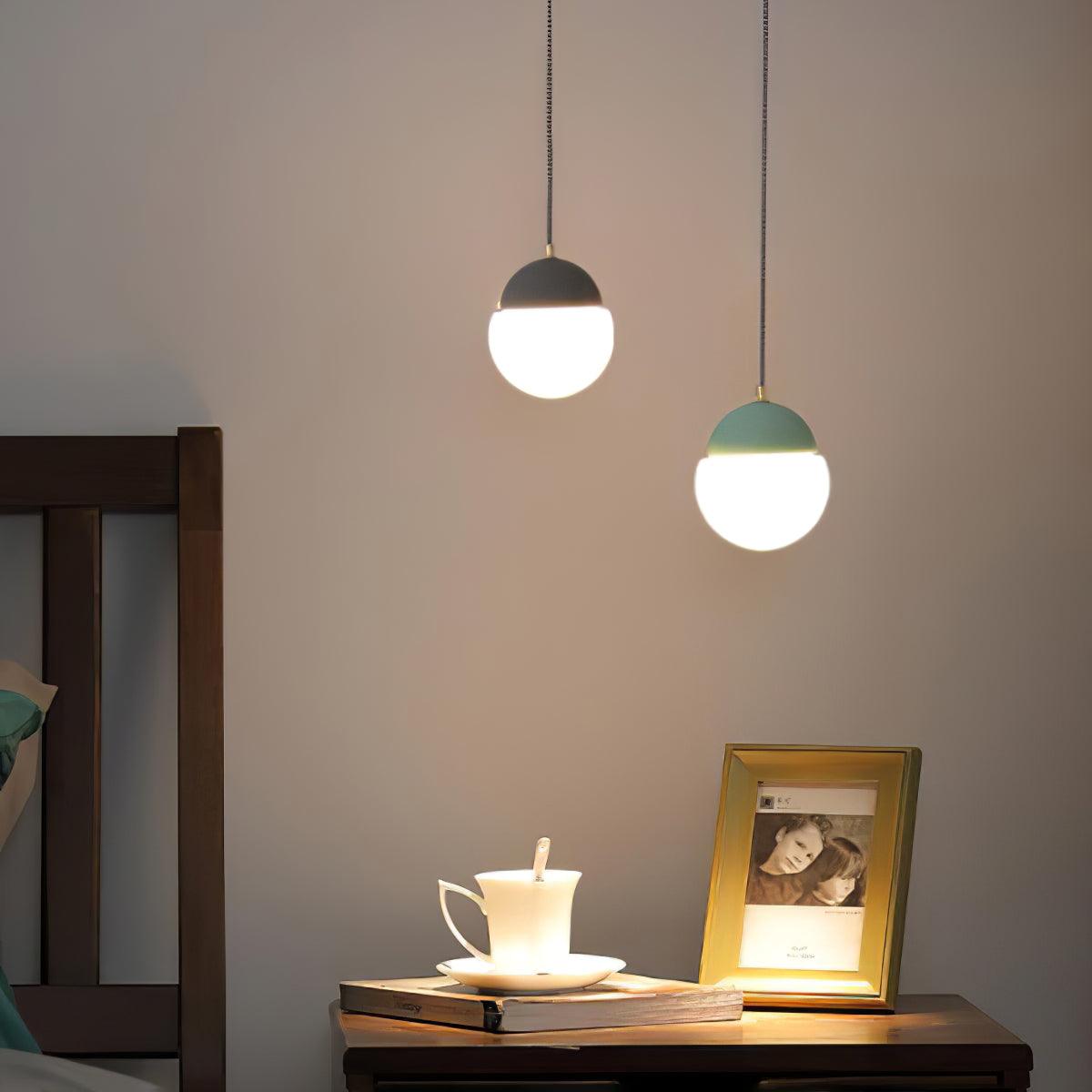 Two coloured cap pendants above a console