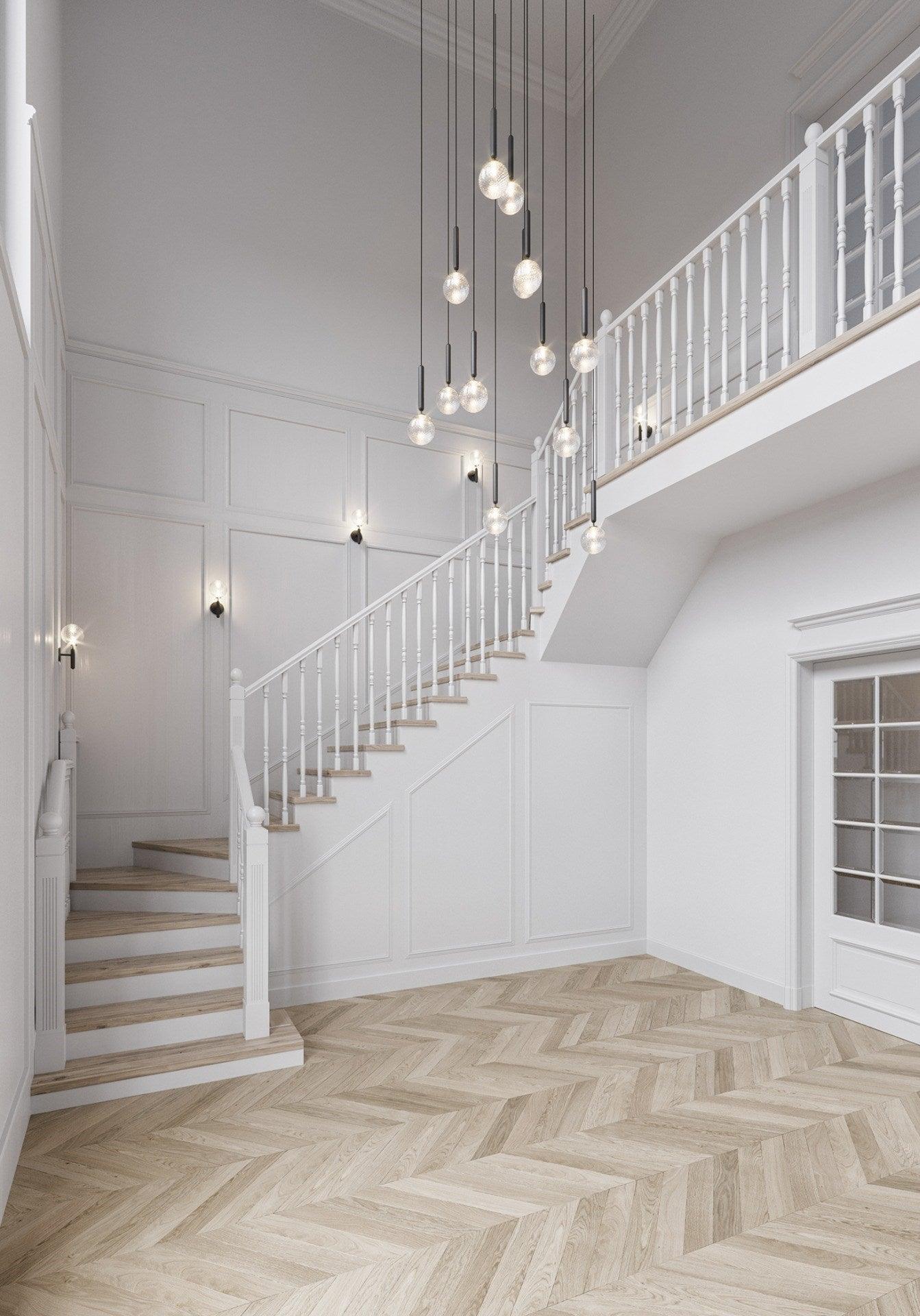 Long white-globe cascade beside a staircase