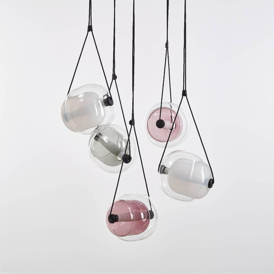 Clear and pink-violet glass pendants in a group
