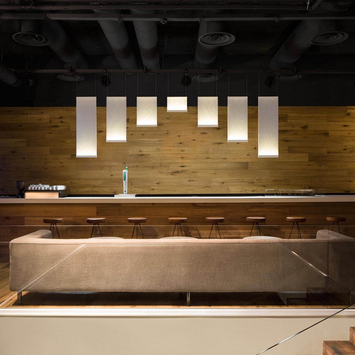 Row of narrow fabric pendants over a bar