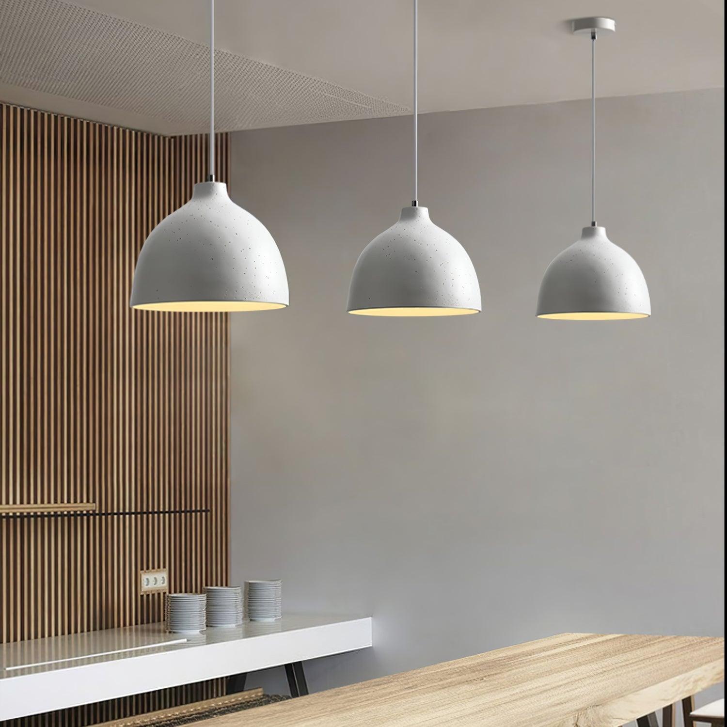 Three white shades above a wooden counter