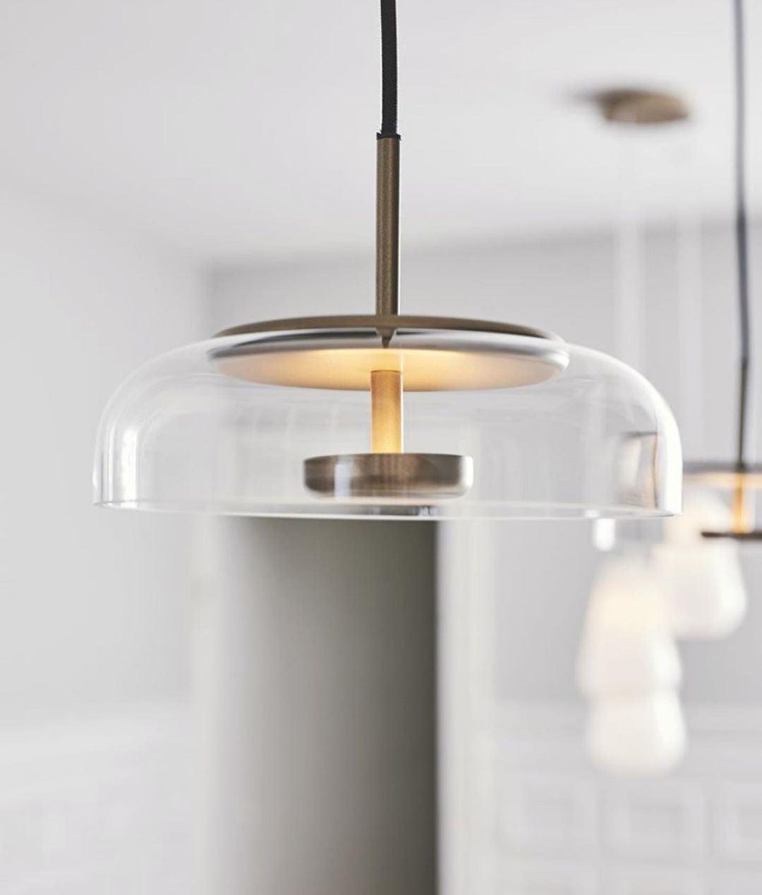 Blossi pendant light with a glass dome and circular inner metal elements