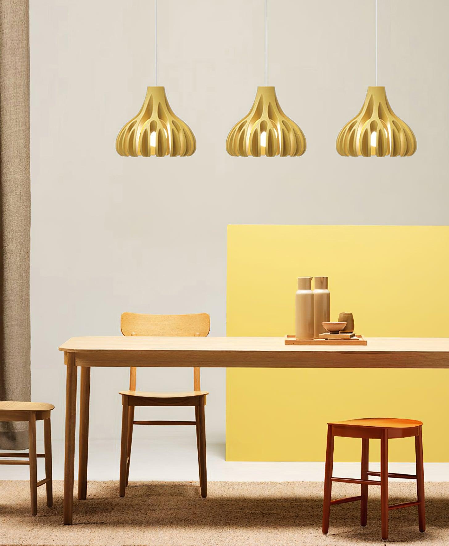 Three Yellow pendants above a wooden table