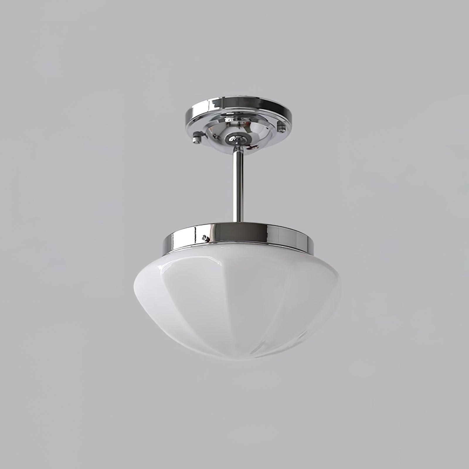 Silver ceiling fitting with a longer stem and white faceted glass bowl