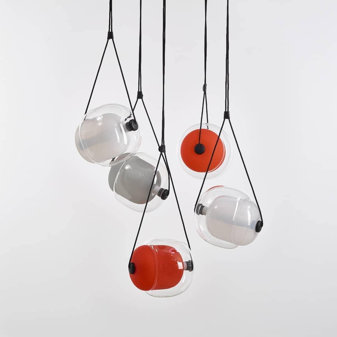 Layered glass pendants in clear and red-toned colours