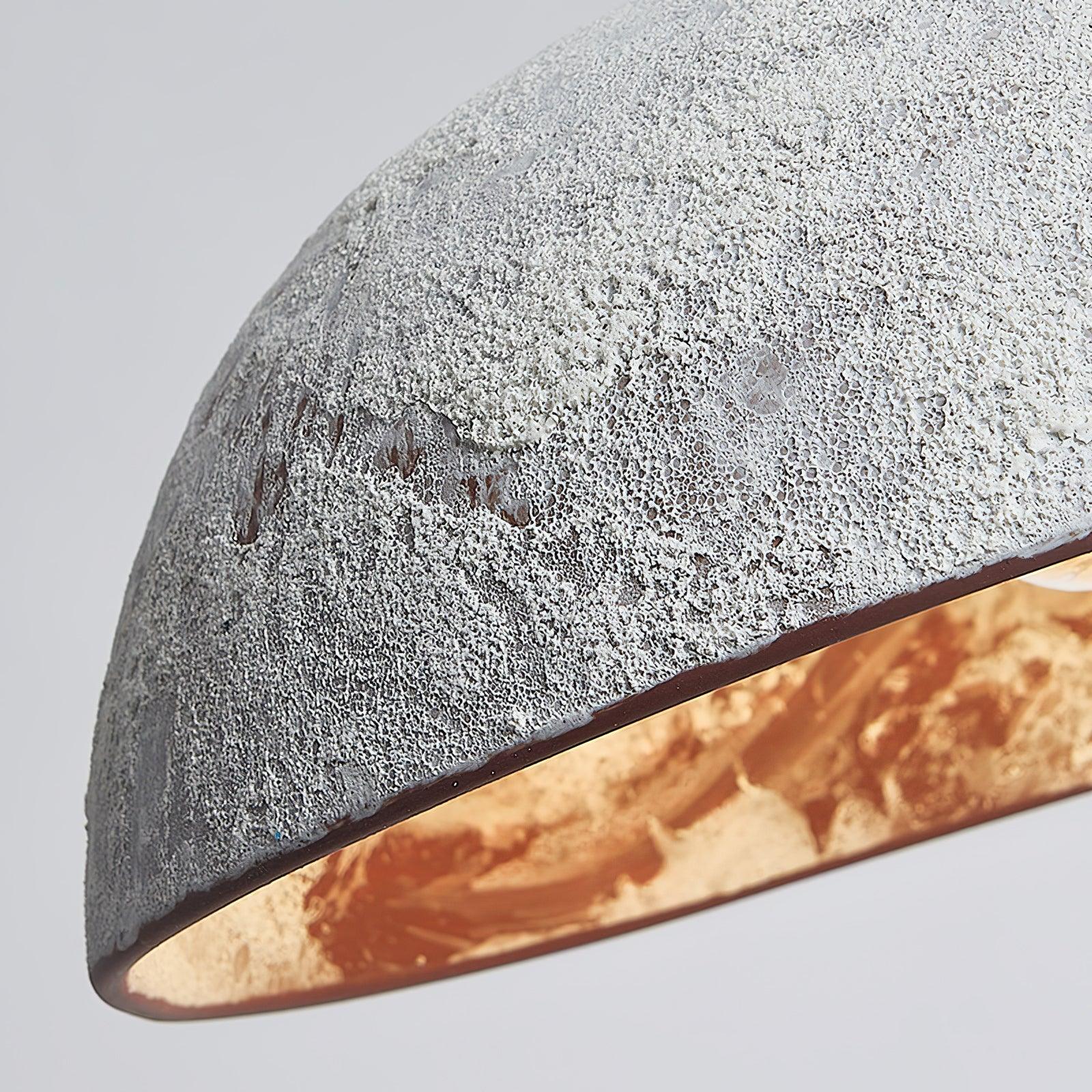 Close view of rough ceramic texture and gold-toned lining