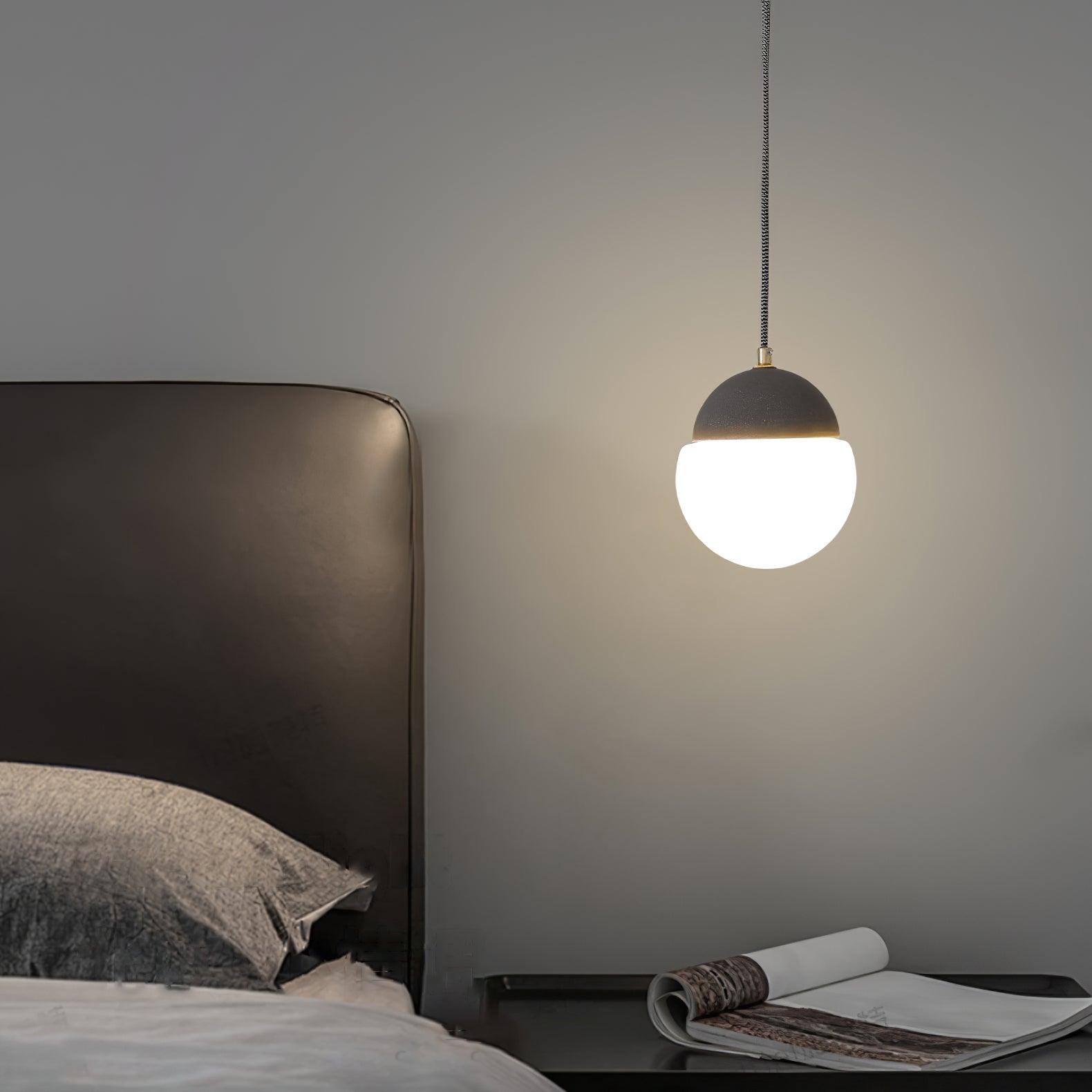 Dark cement cap and White globe beside a bed