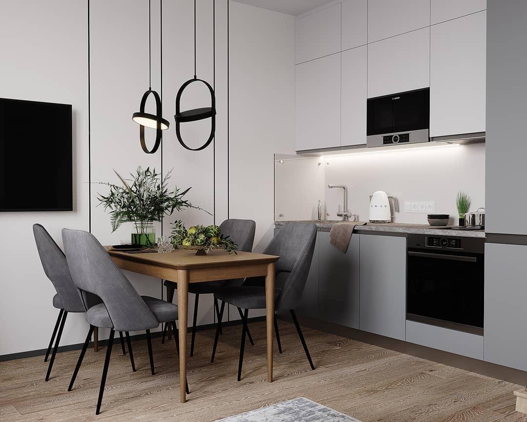 Black oval pendants near a dining table and kitchen
