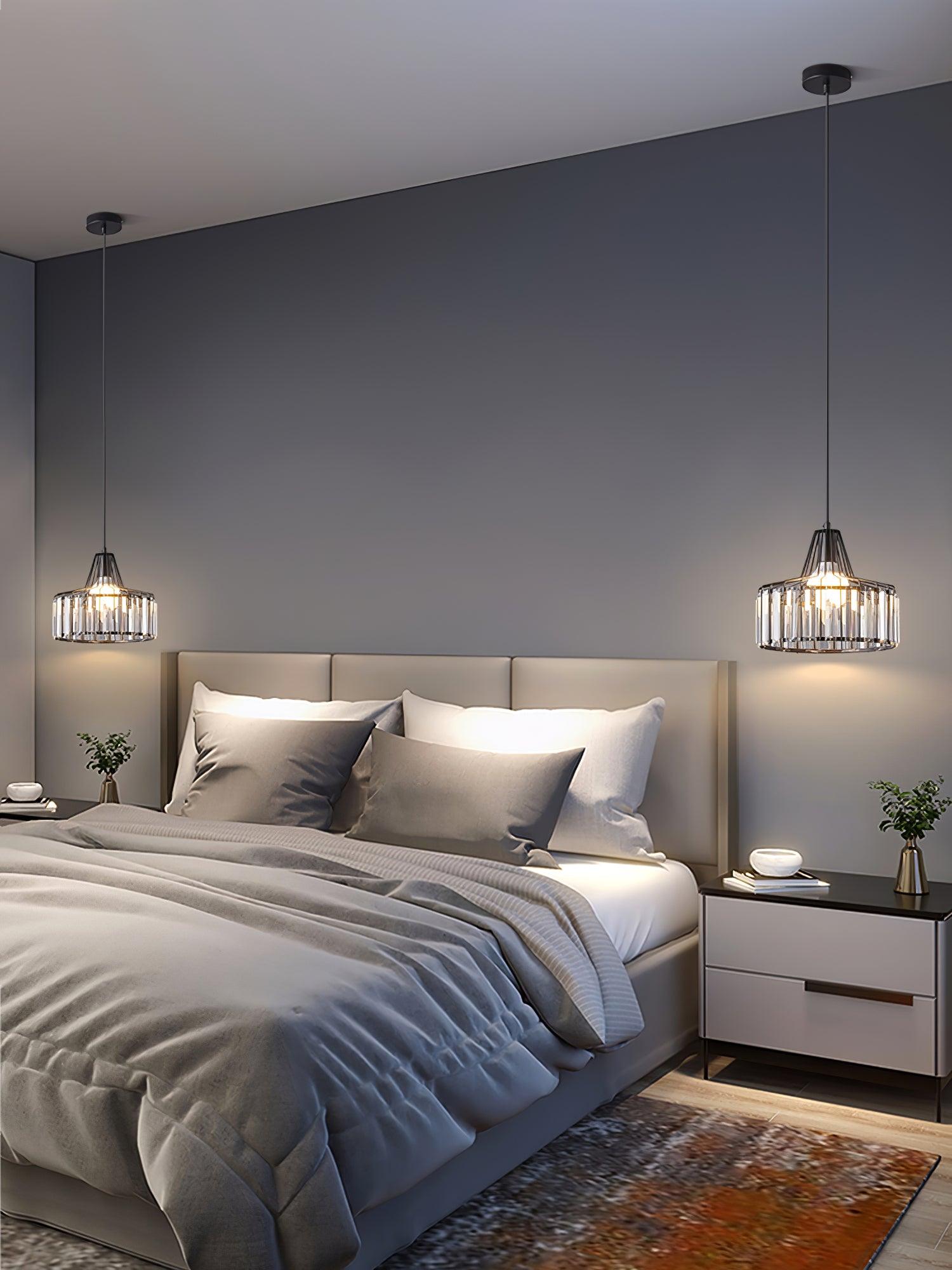 Two black drum pendants flanking a bed