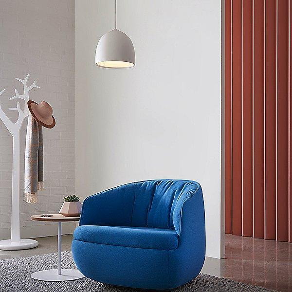 Grey pendant above a blue armchair