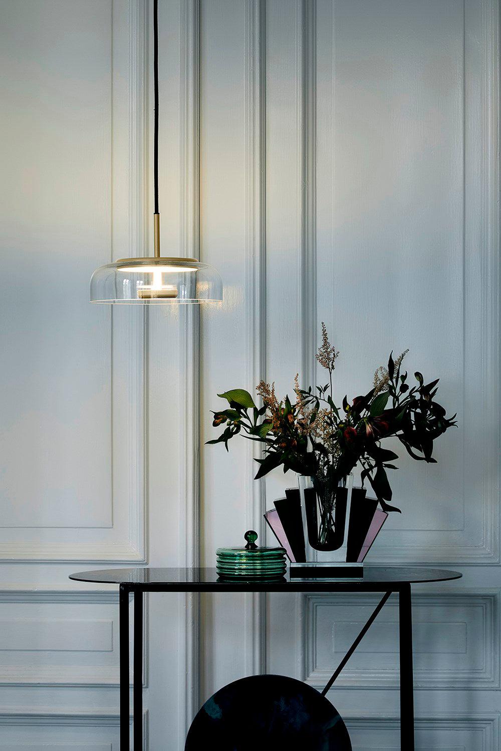Blossi pendant light with a glass dome and circular inner metal elements