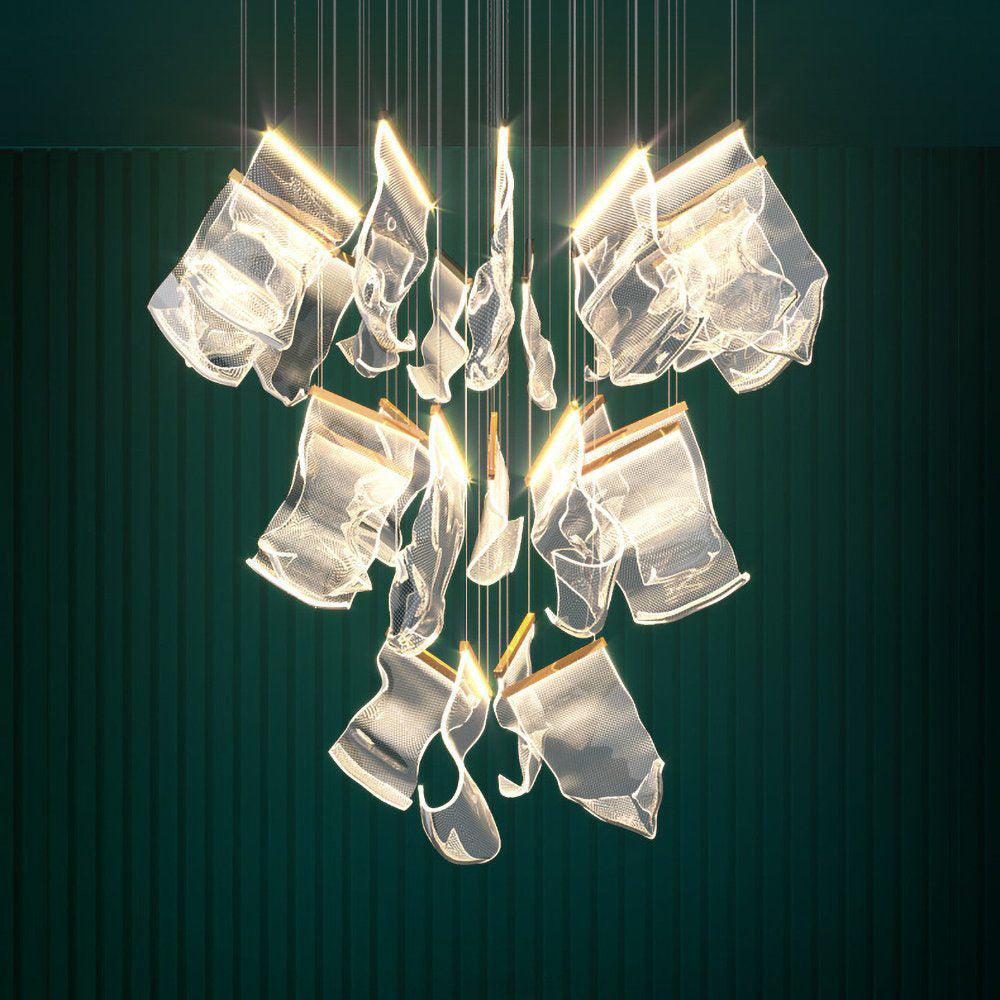 Glowing transparent acrylic chandelier against a green wall