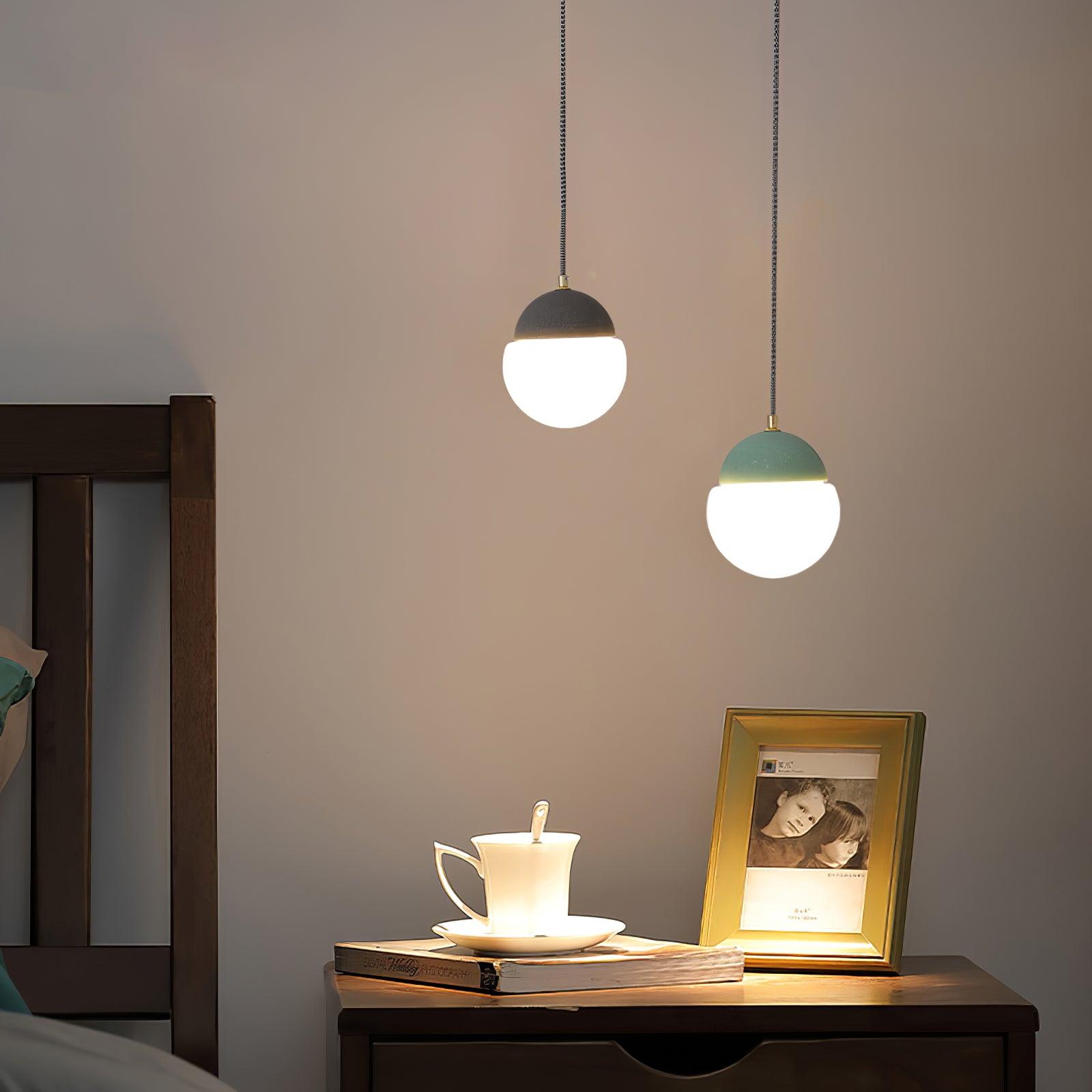 Two globe pendants above a tray and framed photo