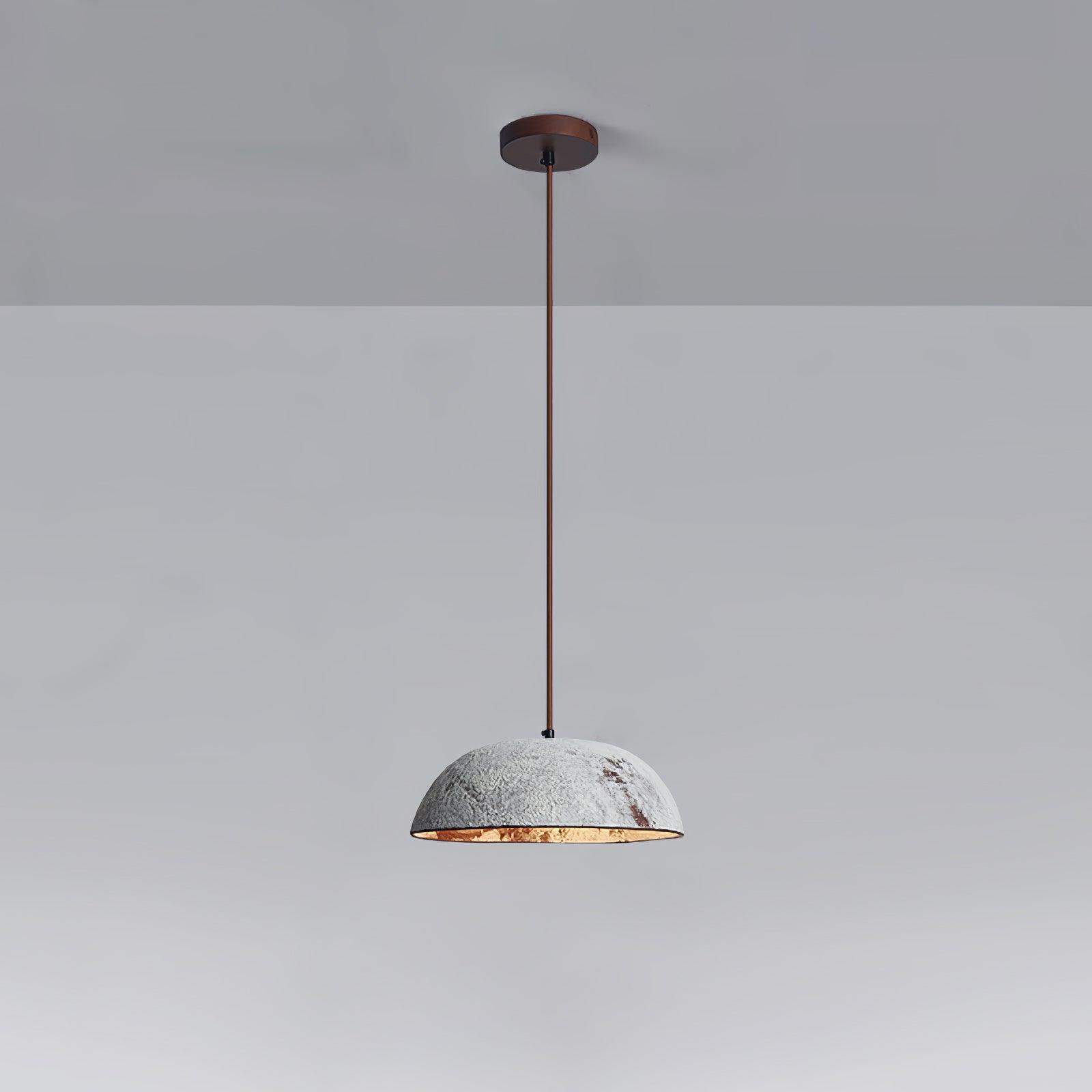 Pale mottled ceramic dome pendant with a gold-toned inner edge and dark suspension