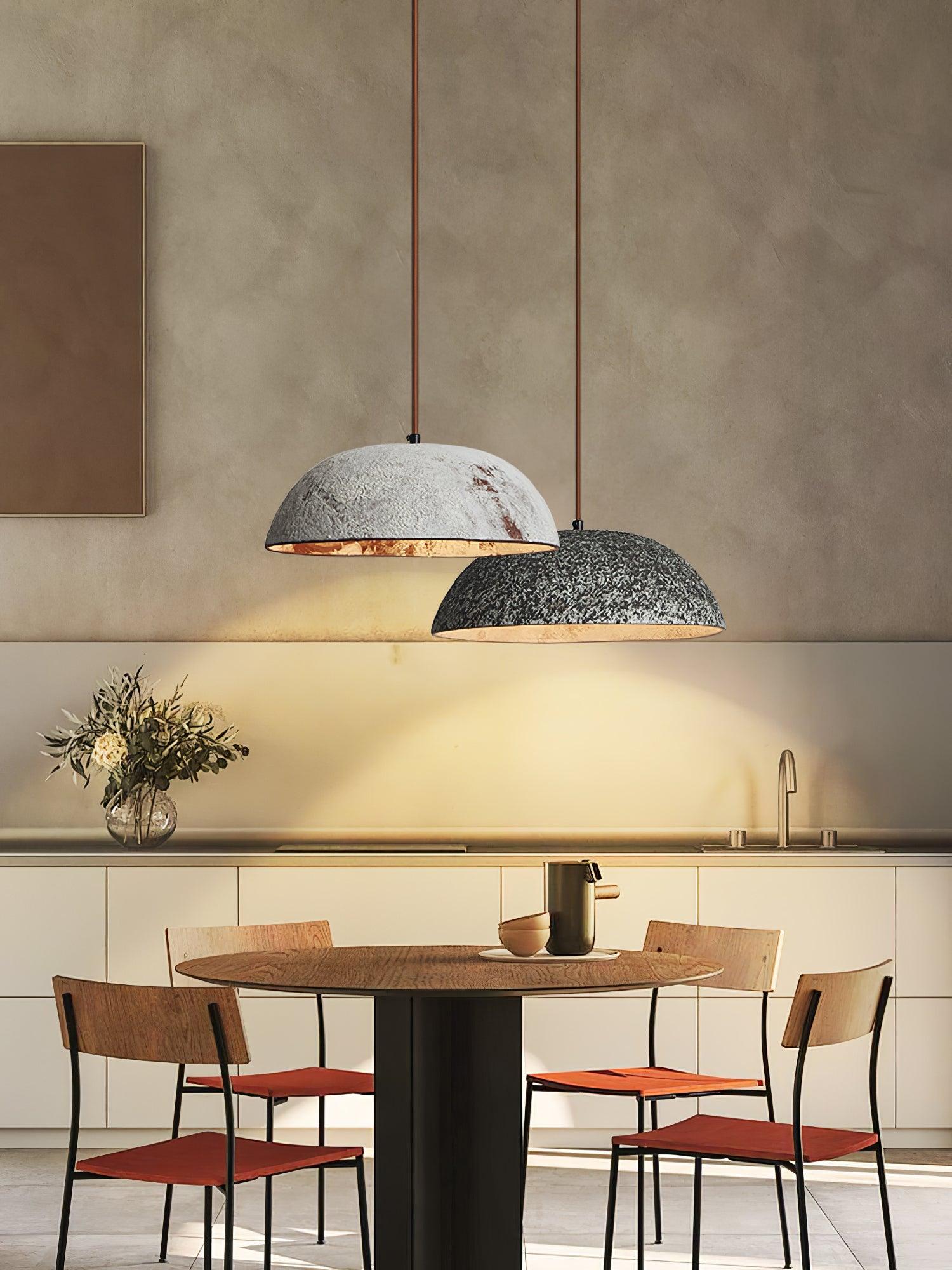 Two half-dome shades above an indoor dining table