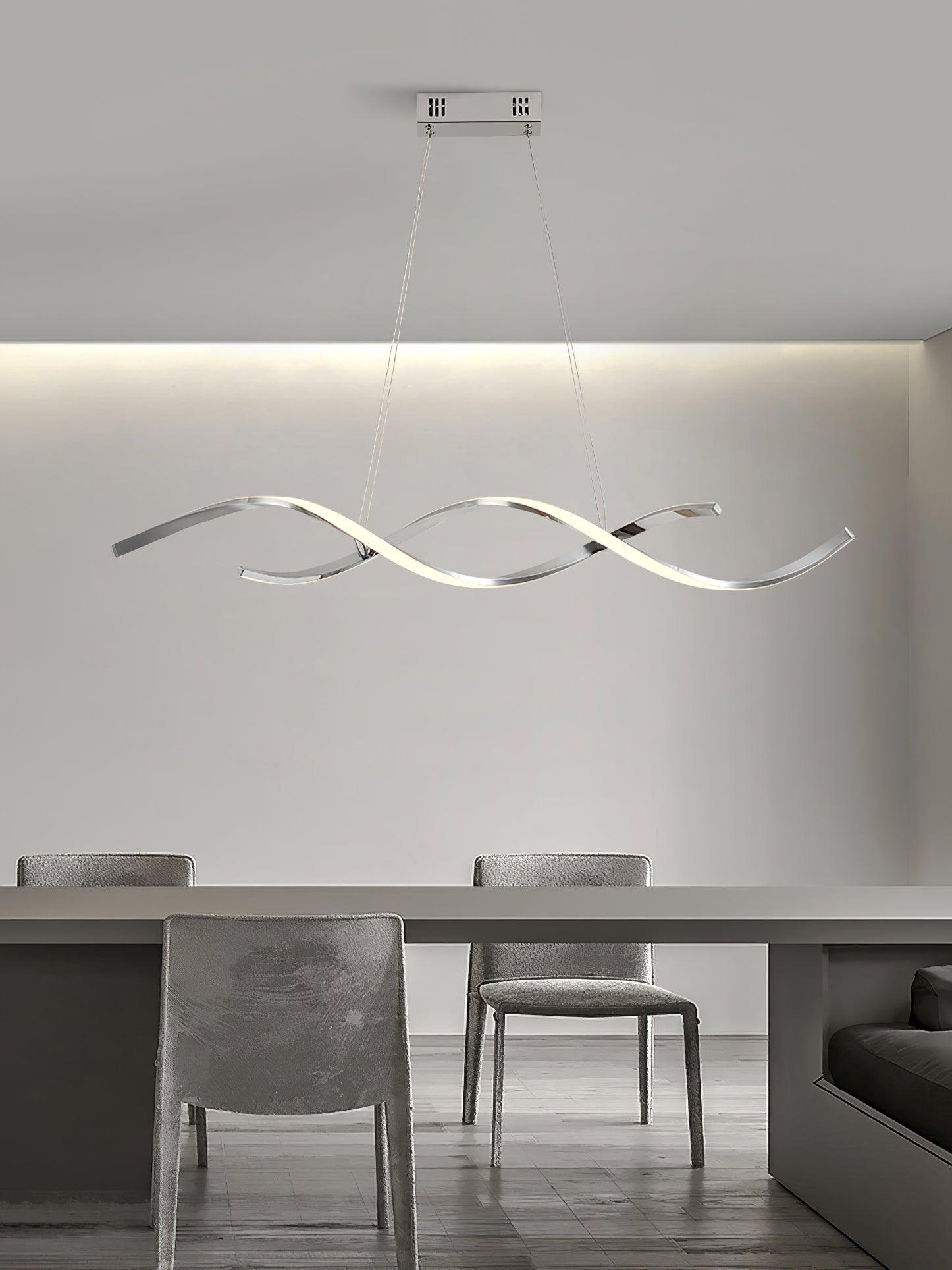 Silver-tone wave pendant and rectangular canopy above a grey table and upholstered chairs