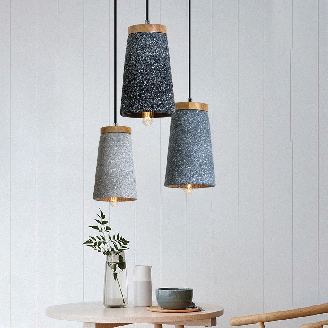 Three differently coloured Coburg pendants above a table
