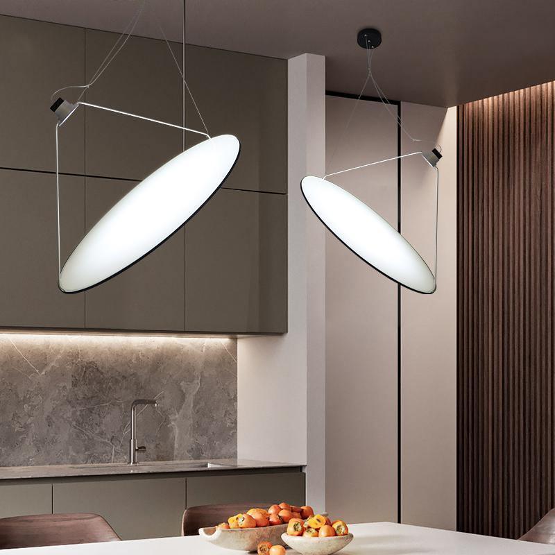 Bright tilted disc pendants over a dark counter