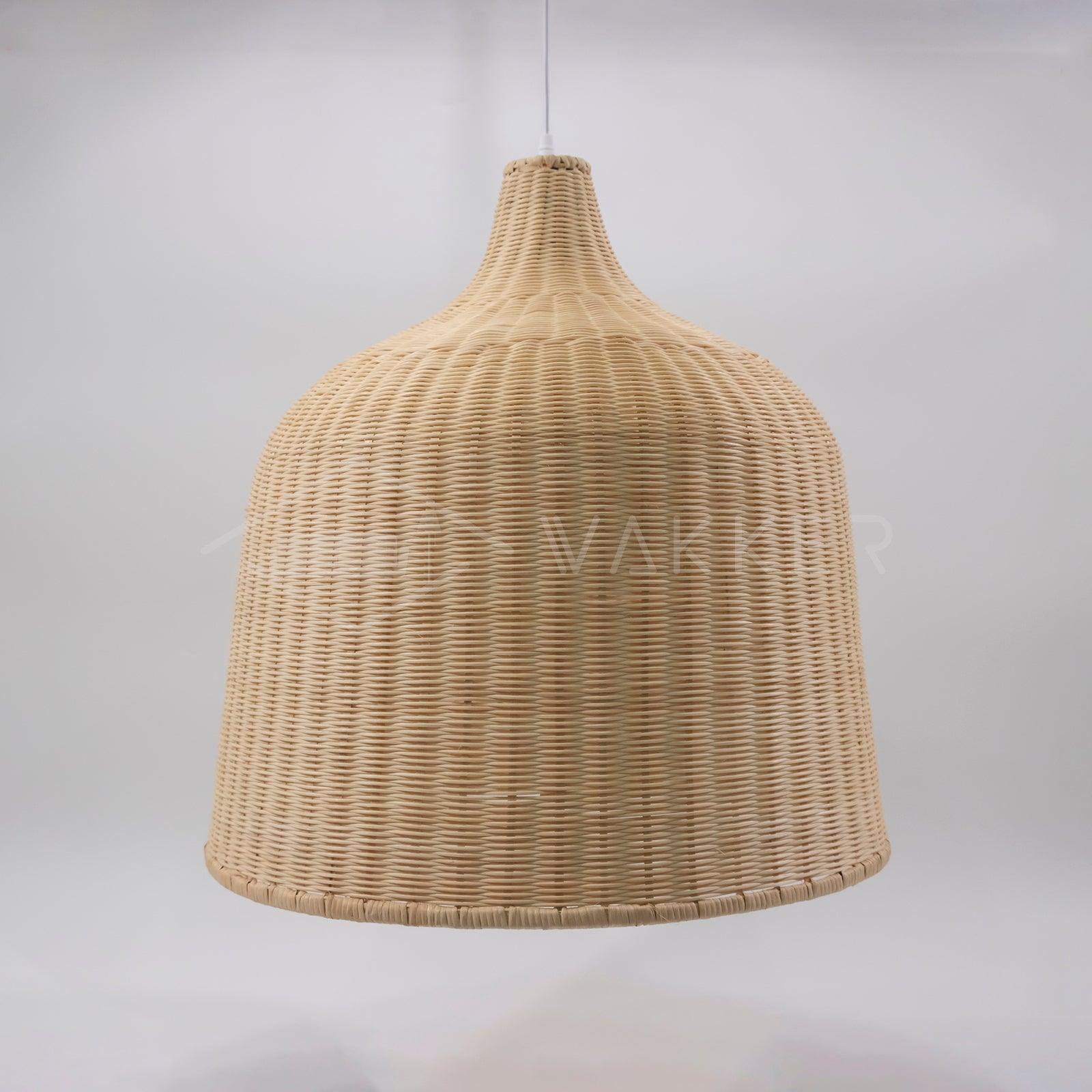 Rounded rattan shade suspended above a pale surface