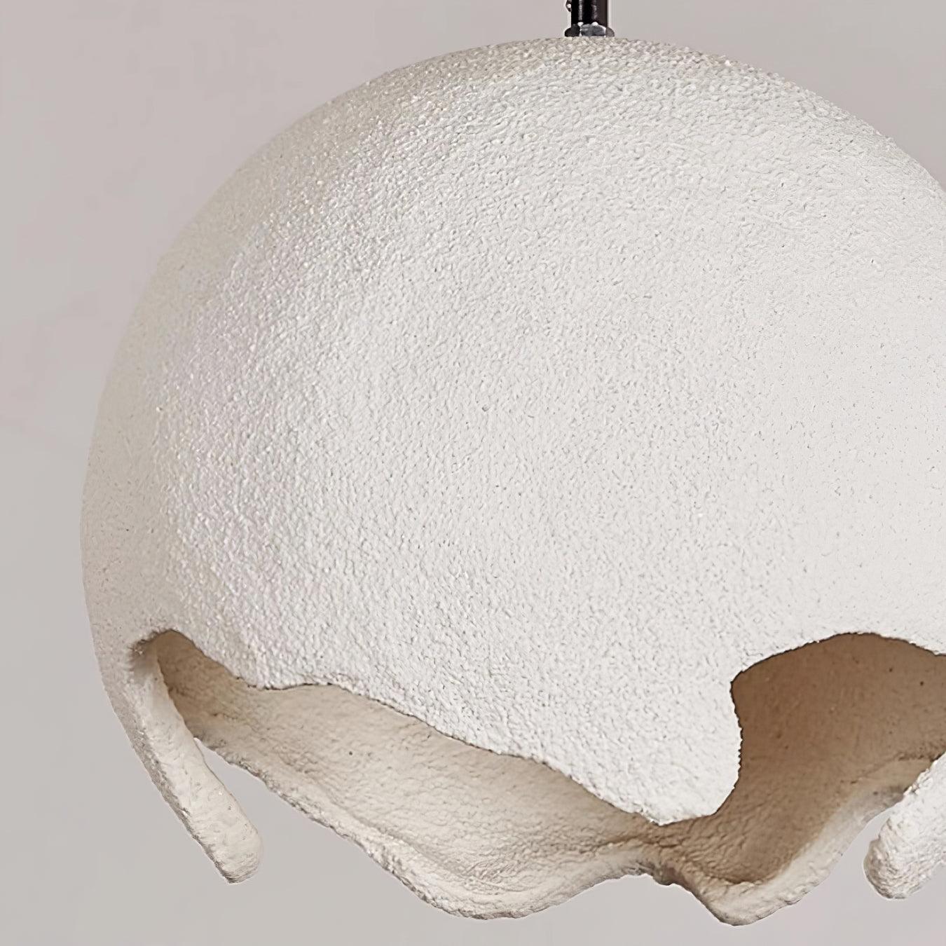Close-up of the grainy white resin surface and curved lower edge
