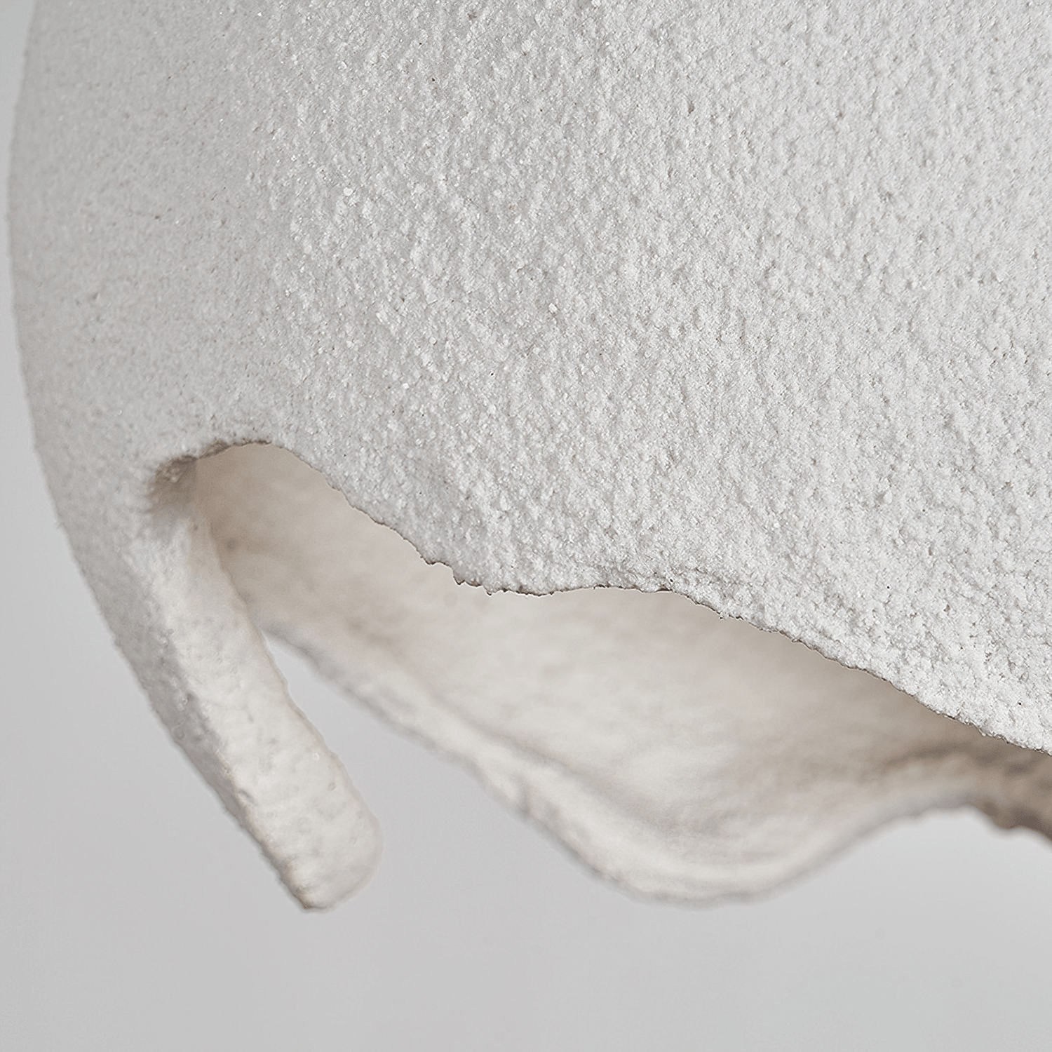 Close-up of the textured white surface and irregular opening