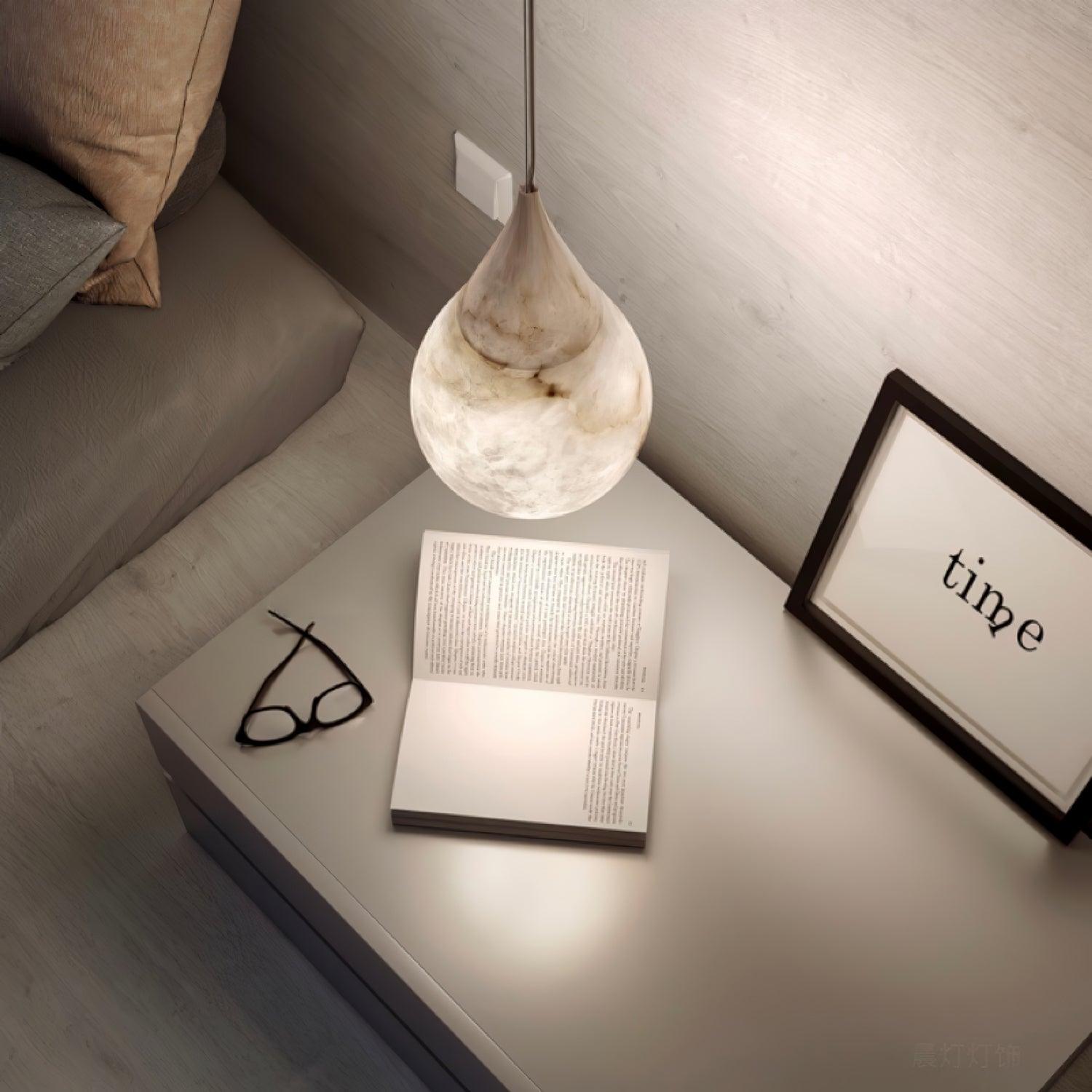 Marble pendant over books on a bedside table