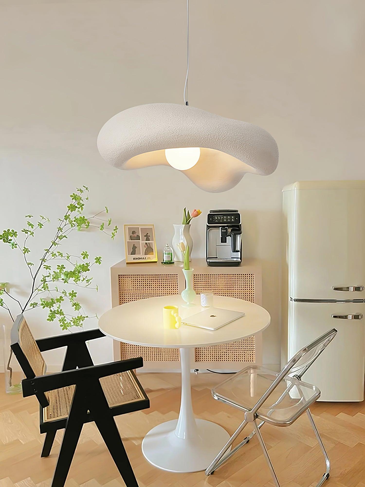 White sculptural pendant above a round table