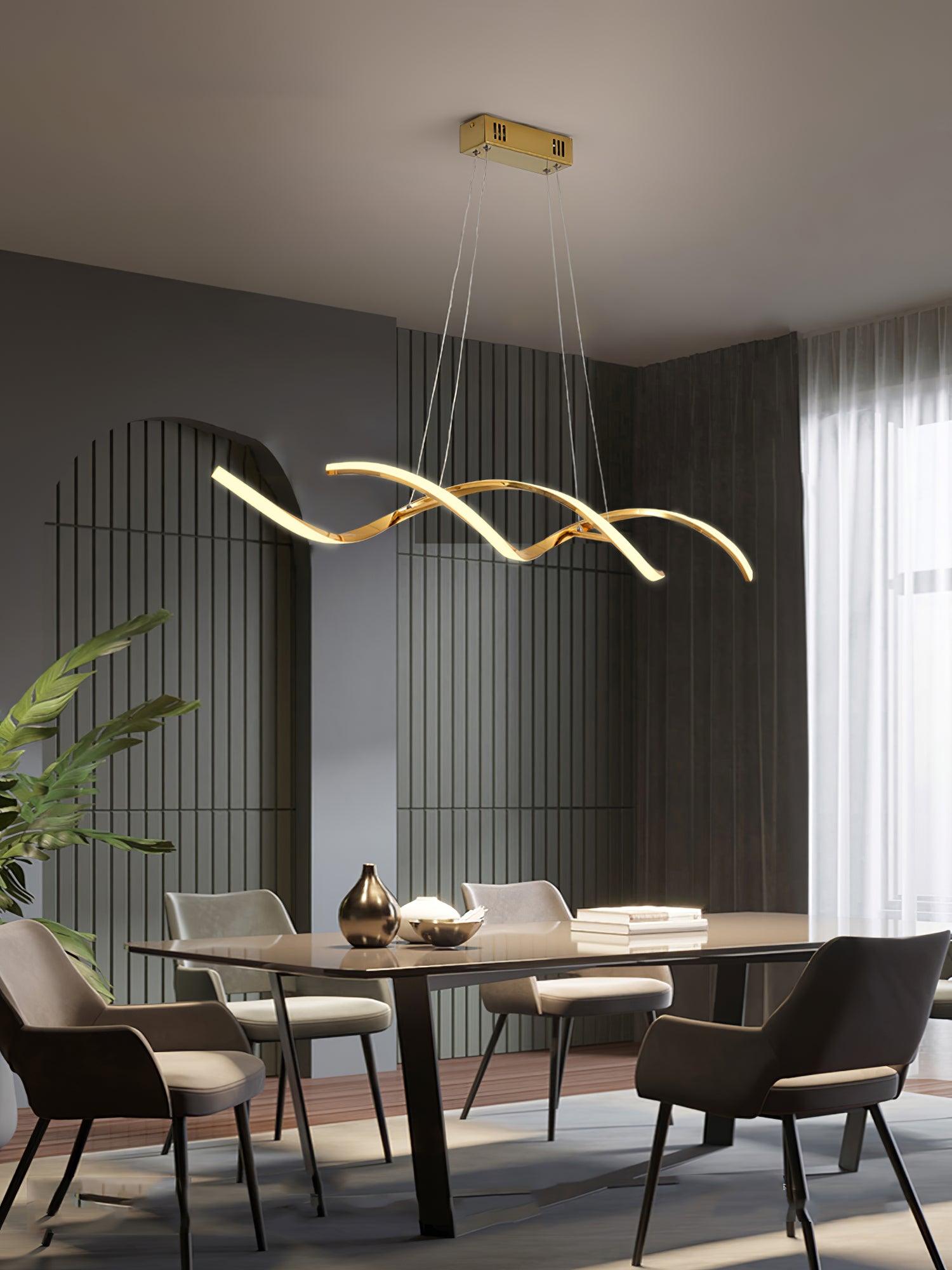 Gold wave pendant and rectangular canopy above a dining table with cream chairs