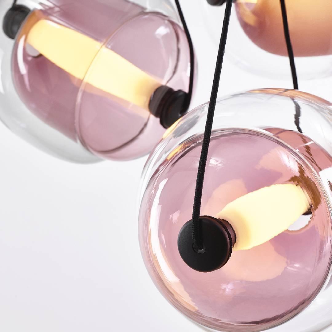 Pink-violet glass capsules viewed at an angle