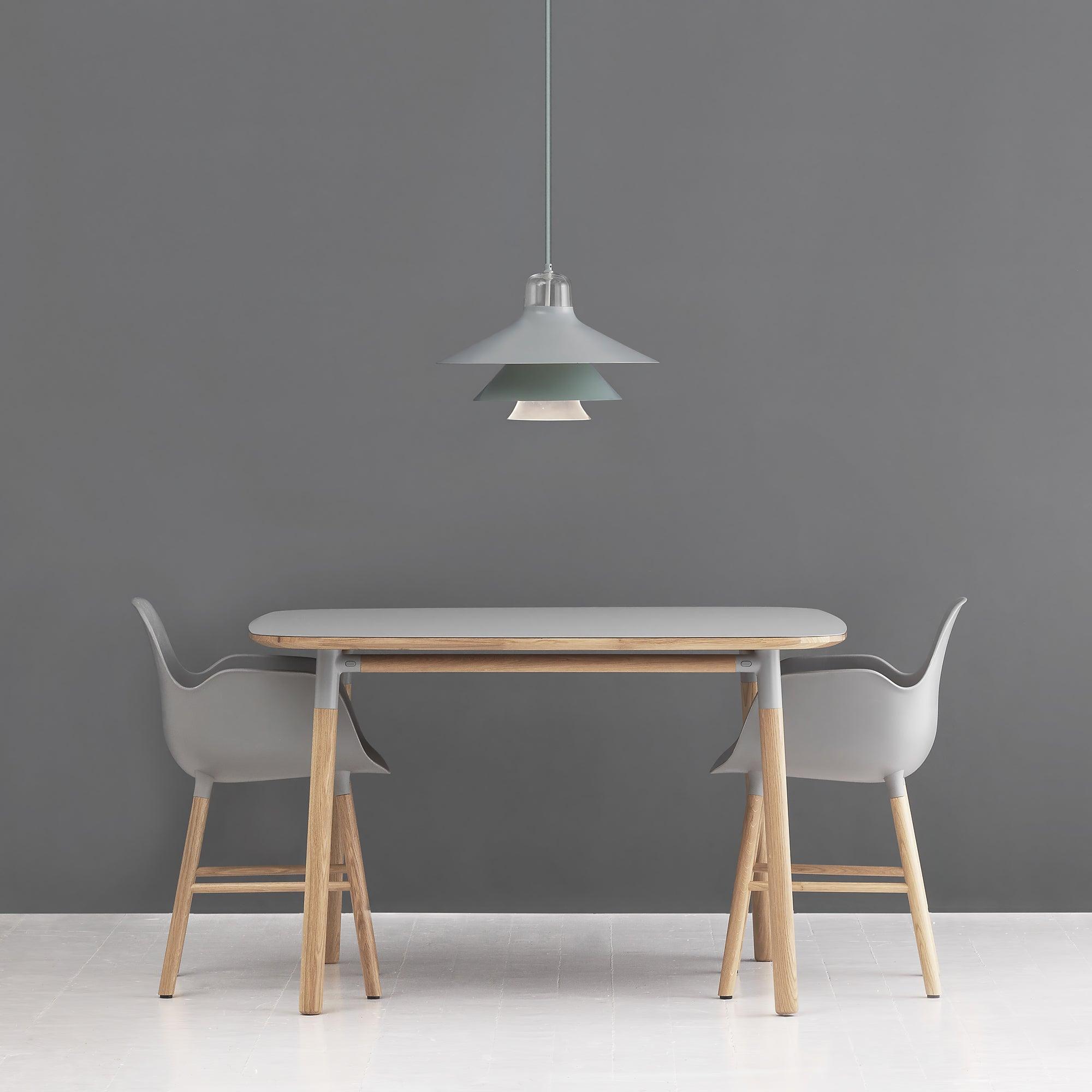 Single pale pendant above a light wooden table