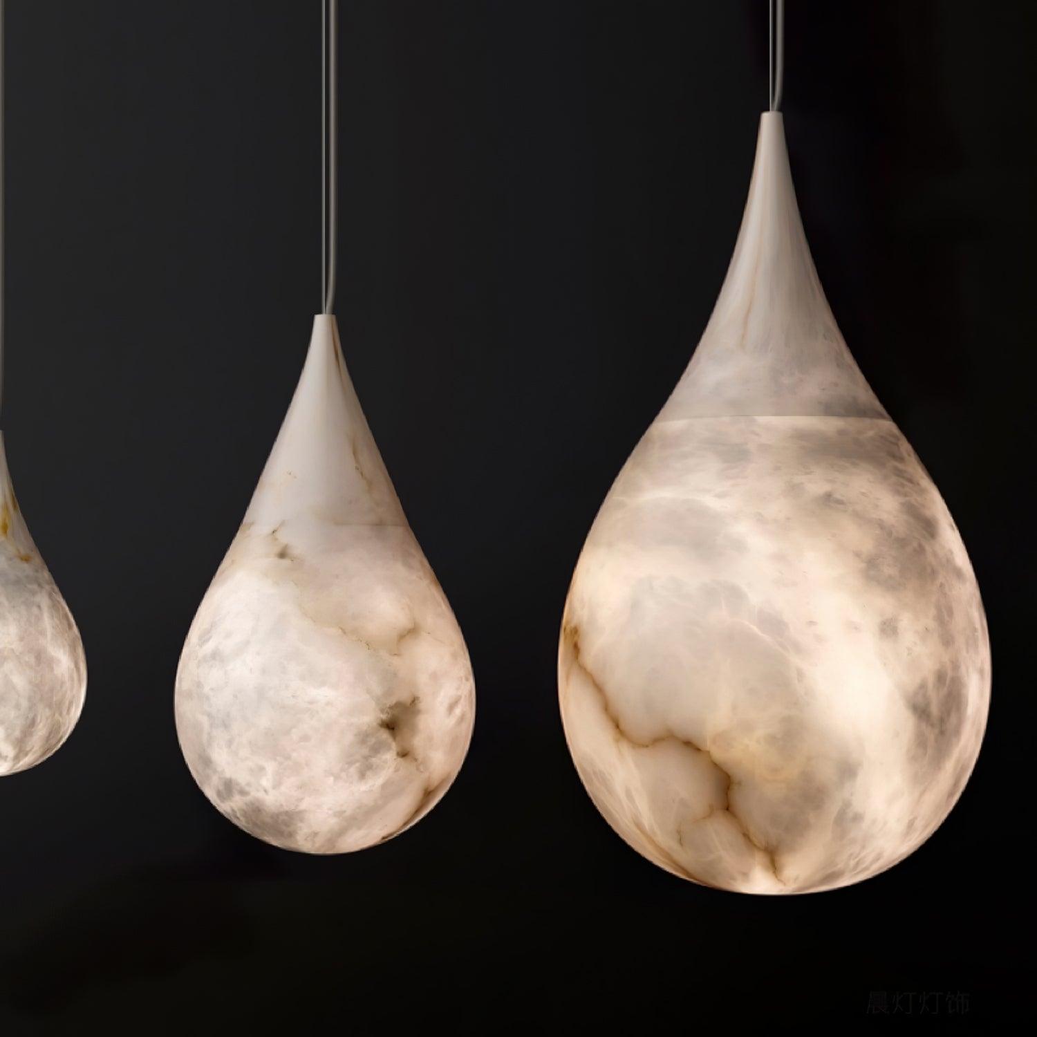 Two illuminated marble teardrops on a black background