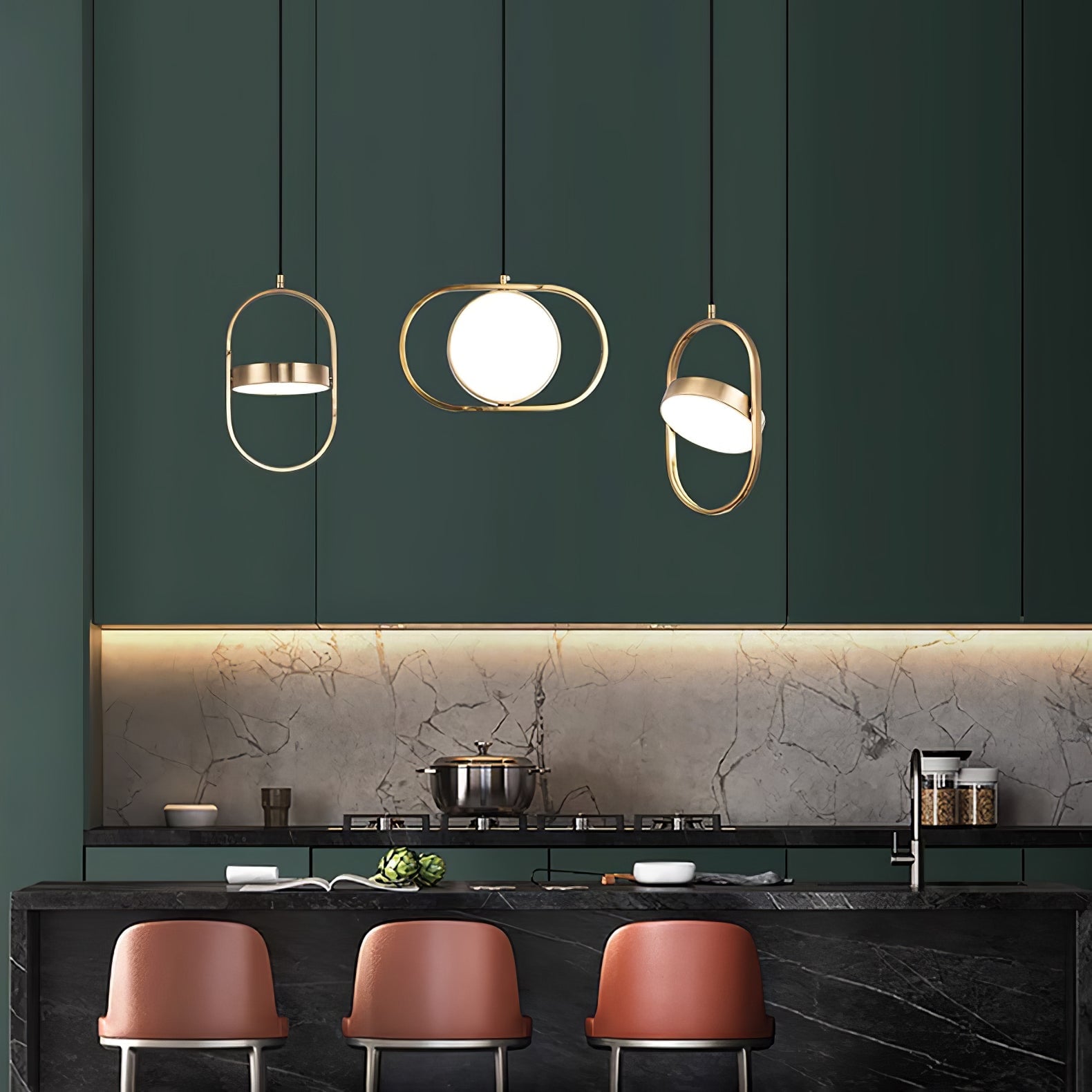 Gold KUU pendants above a kitchen island
