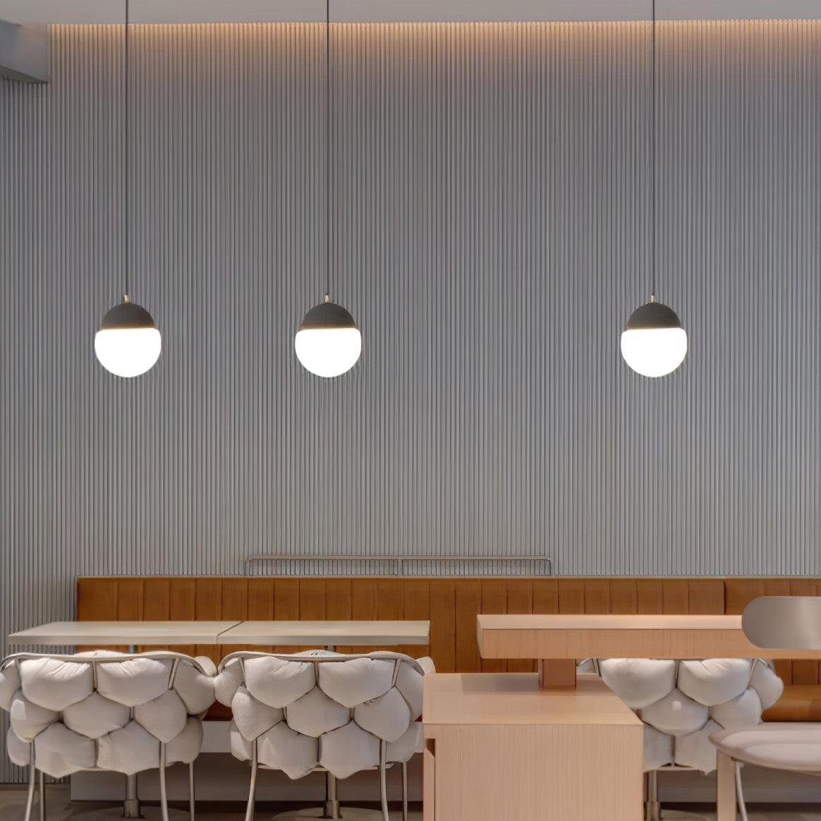 Three globe pendants above a dining counter