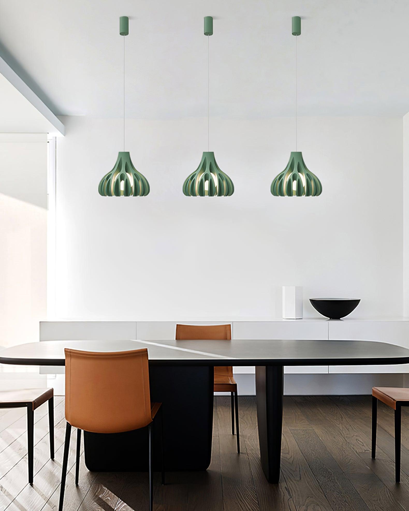 Three Green open pendants above a dining table