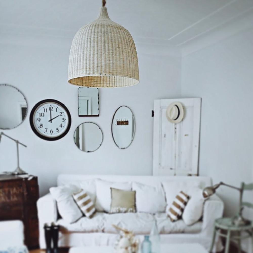 Rattan pendant in a living room with wall clocks