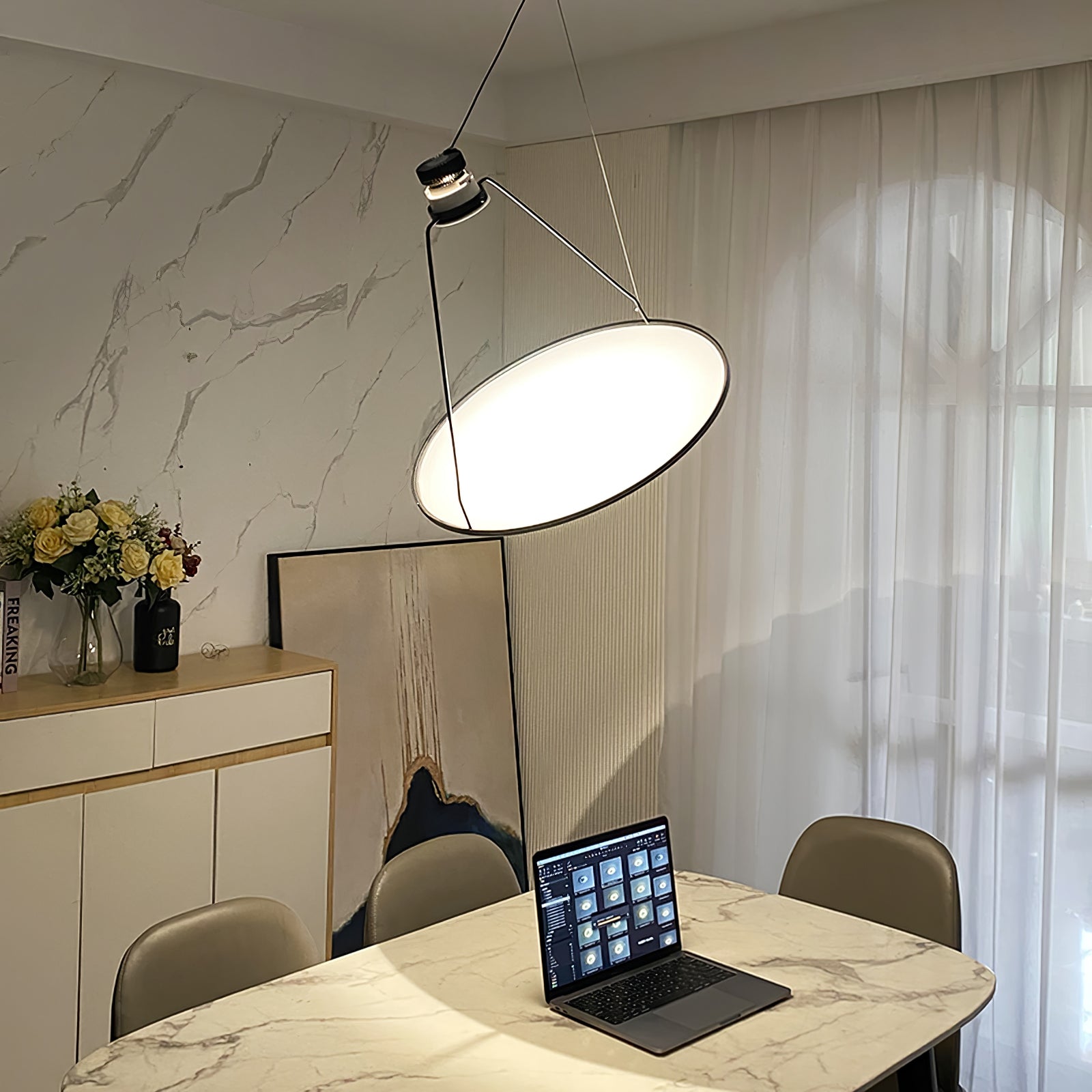 Angled glowing disc above a table with a laptop