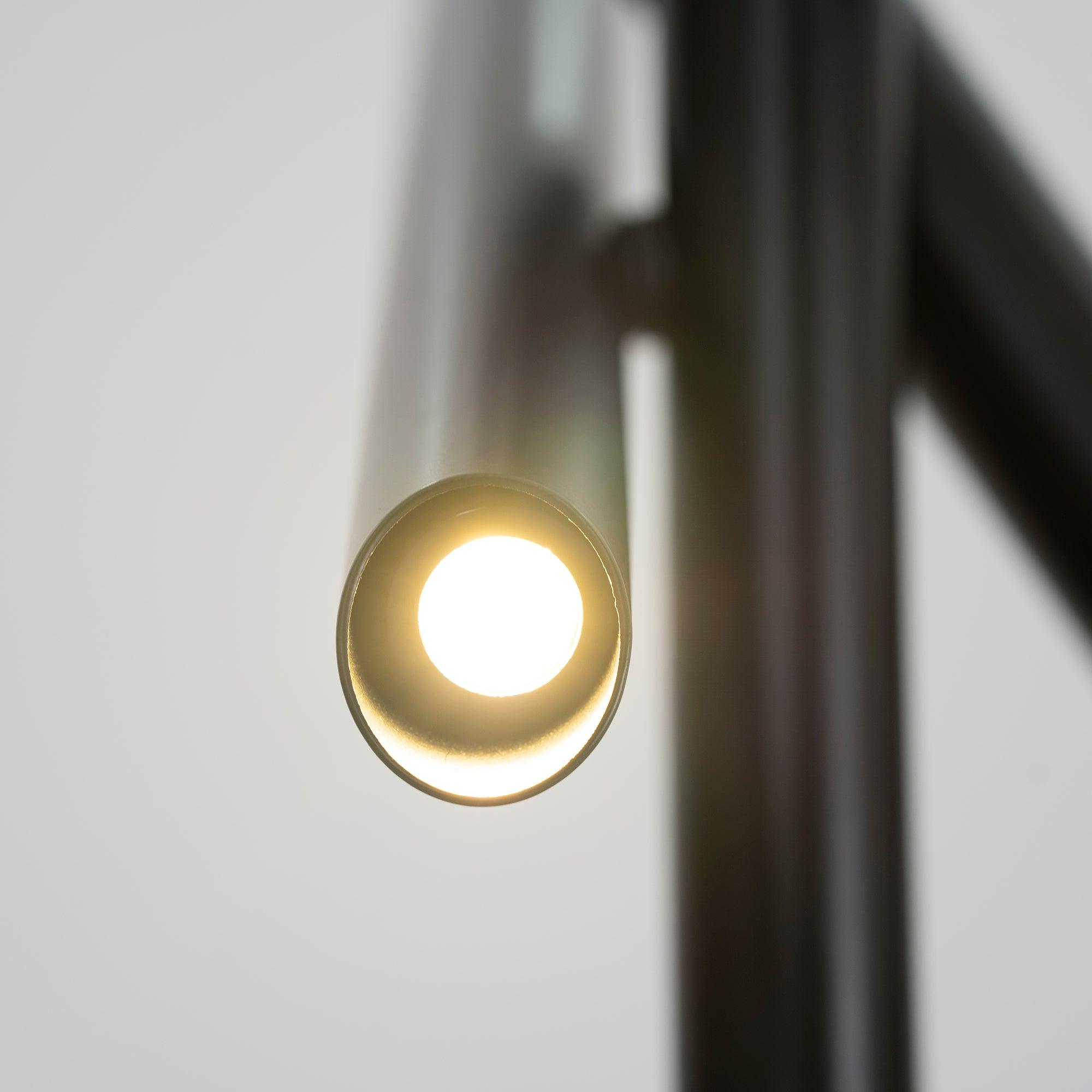 Front close-up of a glowing circular light recessed inside a black Tubes cylinder