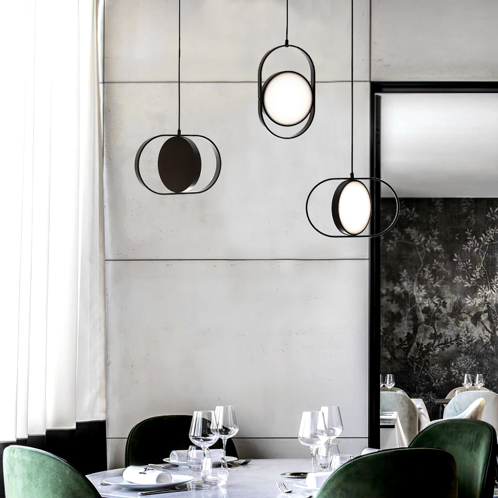 KUU pendants over a table with green chairs