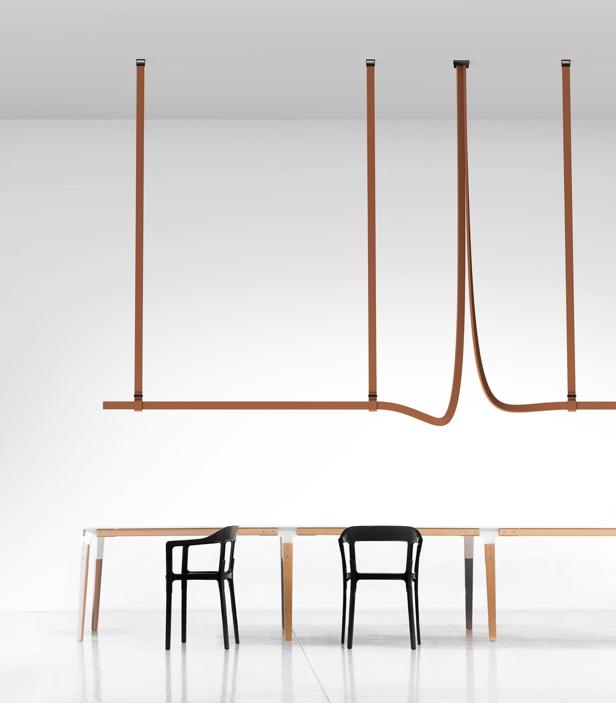 Multiple brown strap profiles above simple chairs