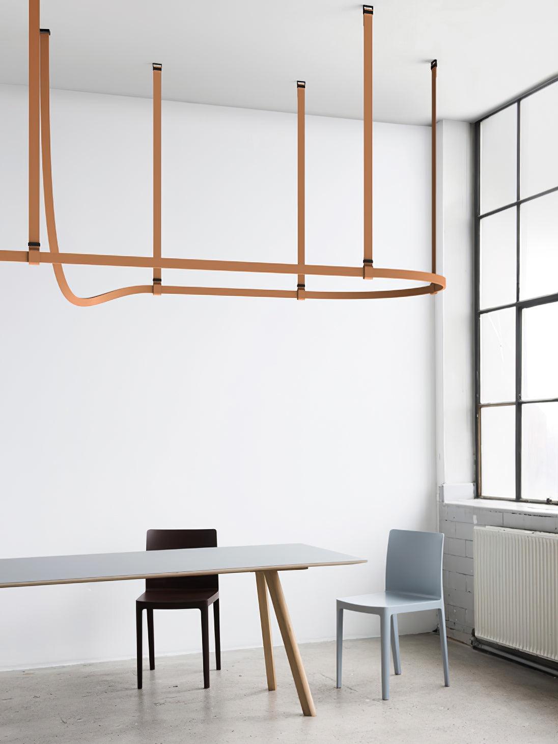 Brown looping suspension above a minimalist table