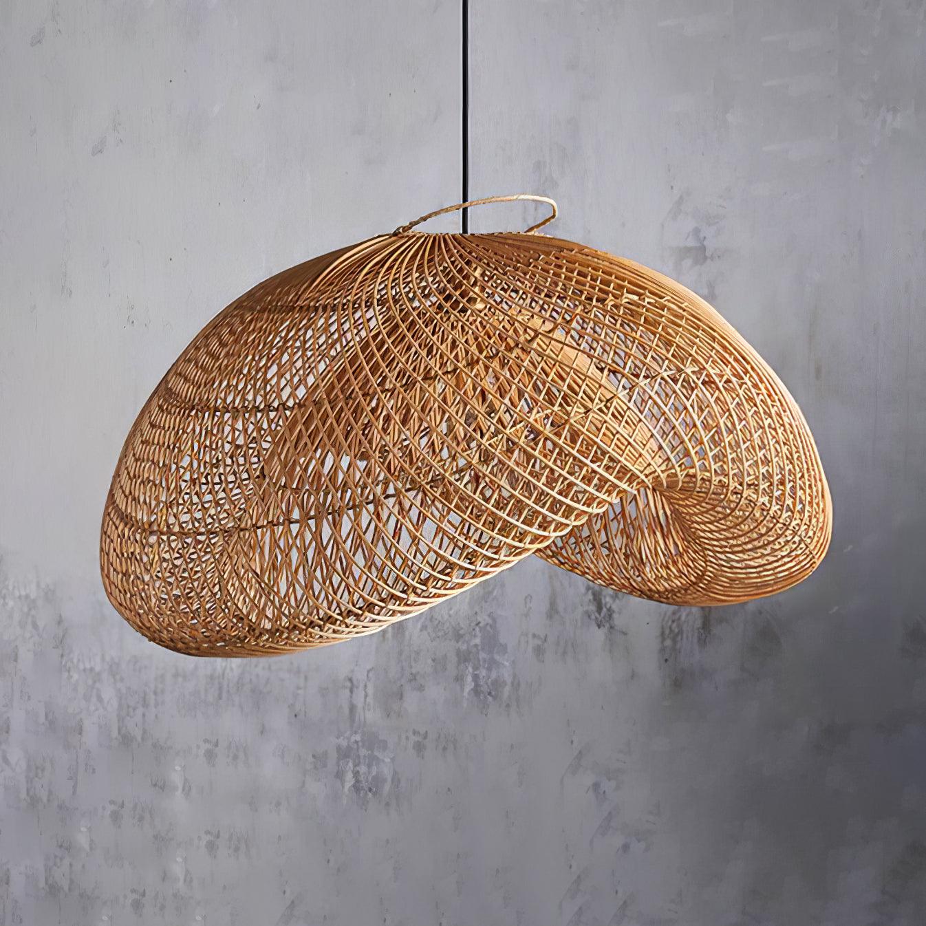 Unlit tan woven wave shade with curved rim, top loop and black hanging cord against a grey wall