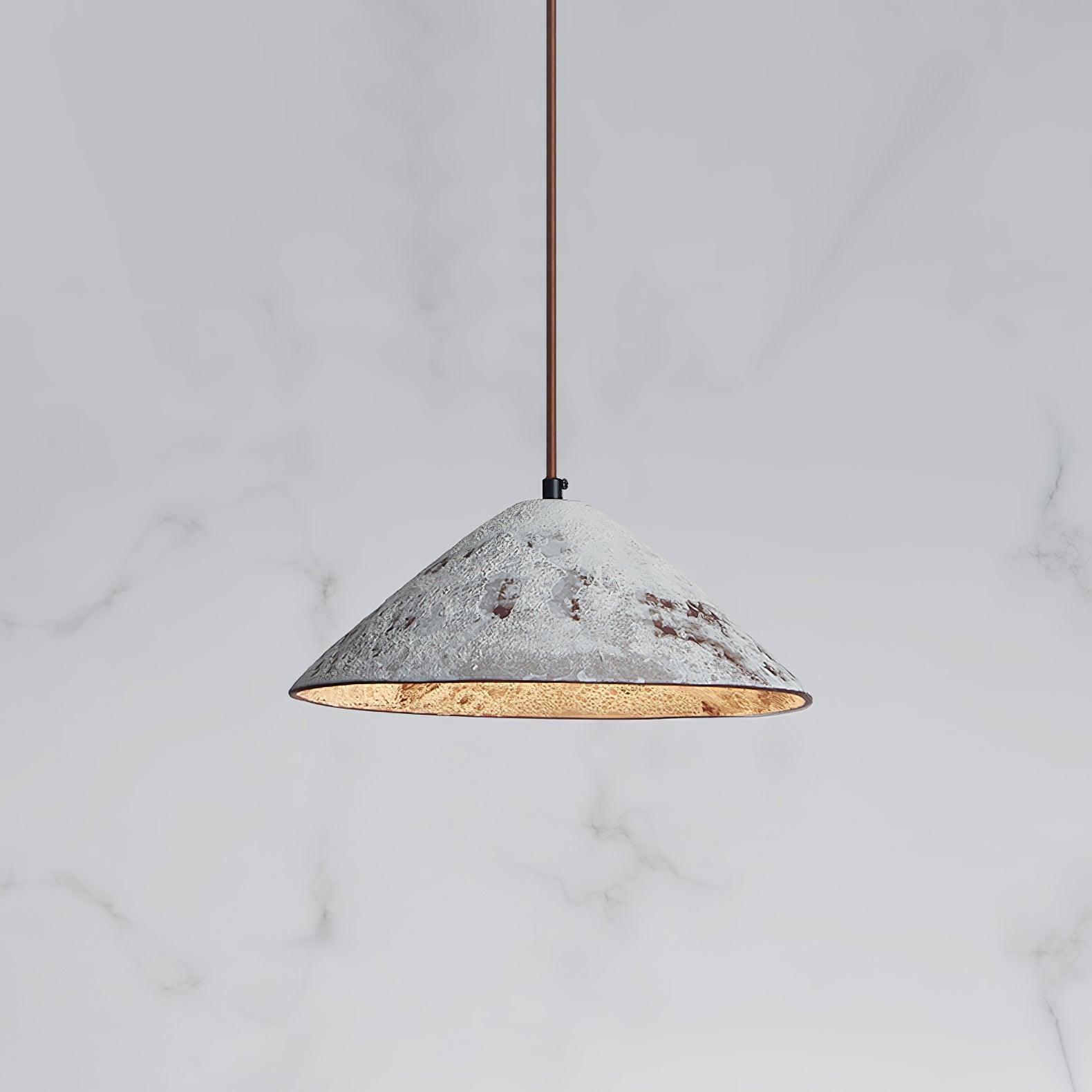 White ceramic cone close-up with brown distressed patches, brown cord and glowing interior against pale veining