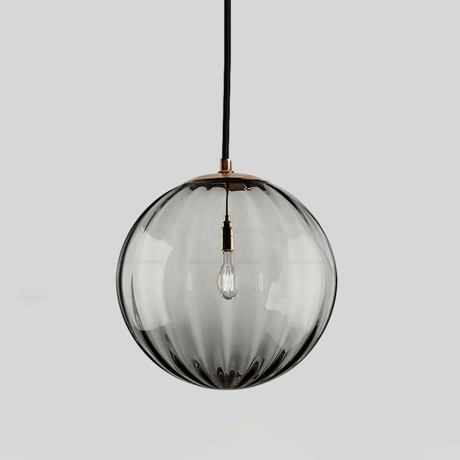 Paola pendant light with a coloured glass globe and small metal cap