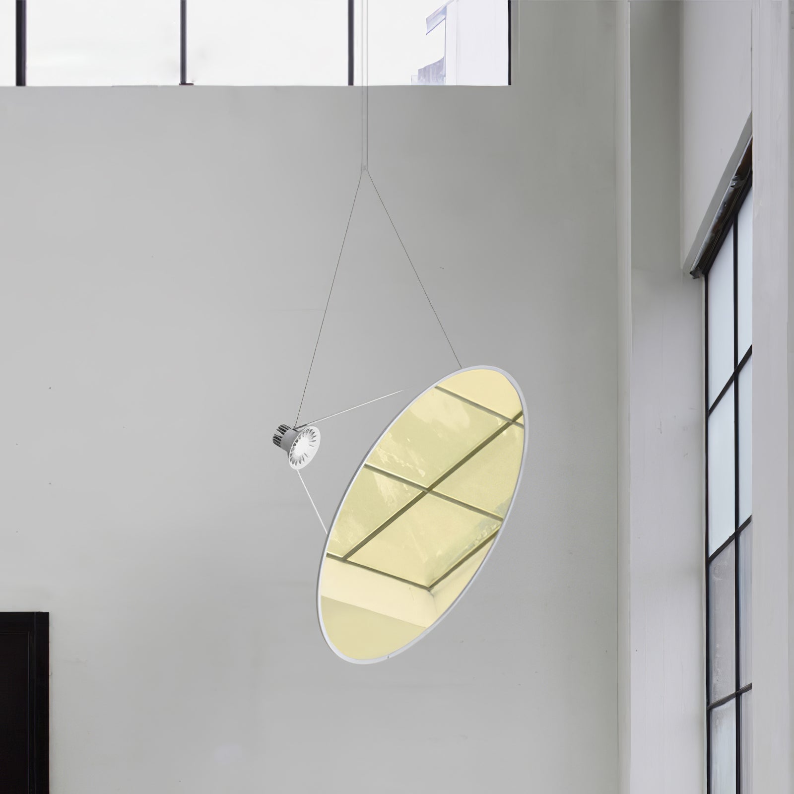Gold-toned circular reflector showing window reflections