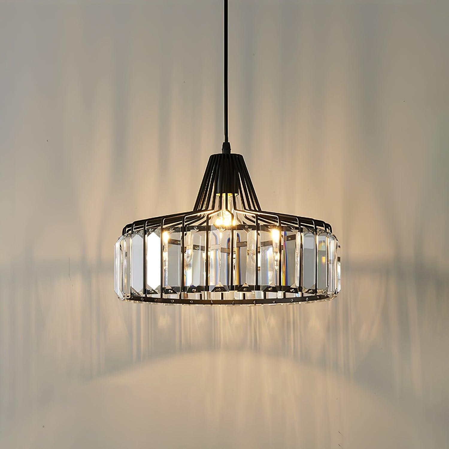 Lit black drum pendant casting patterns on a wall
